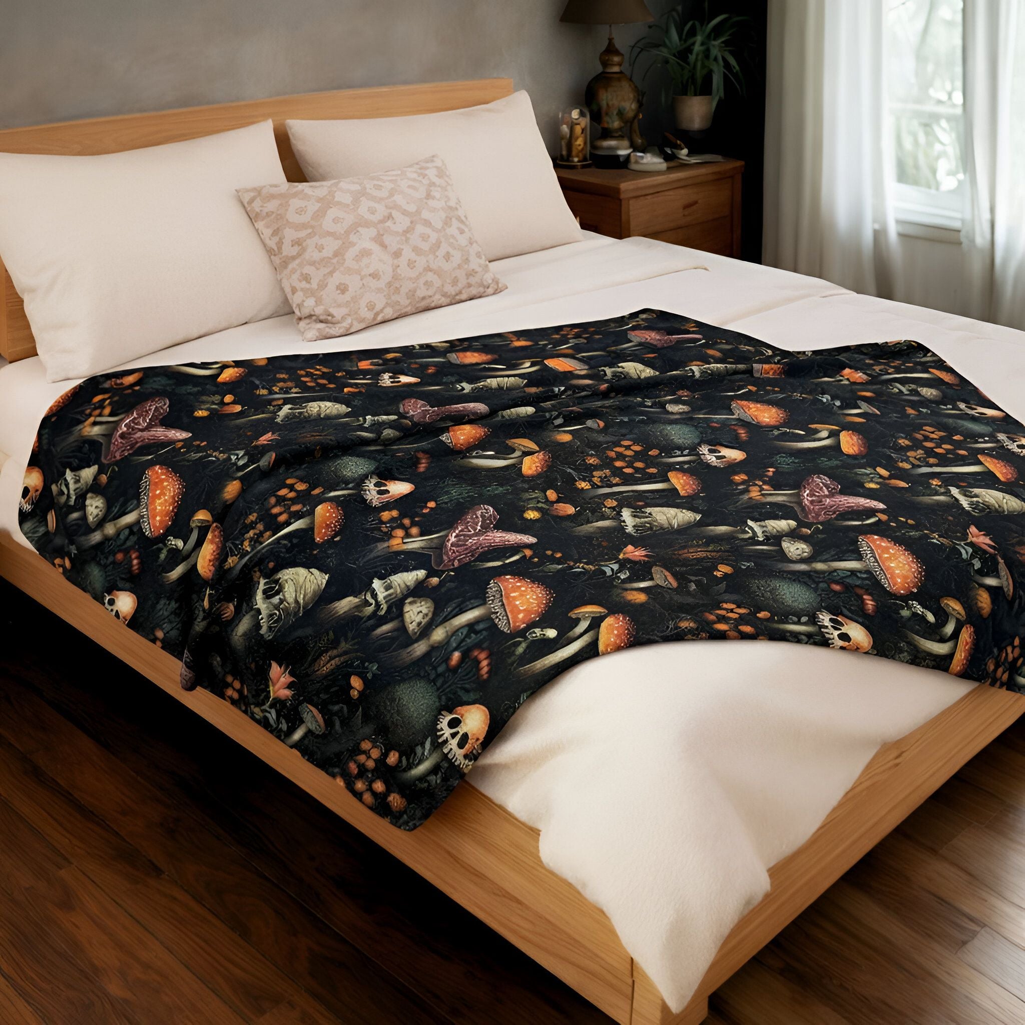 Bed with a decorative blanket featuring spooky mushrooms in a bedroom setting.