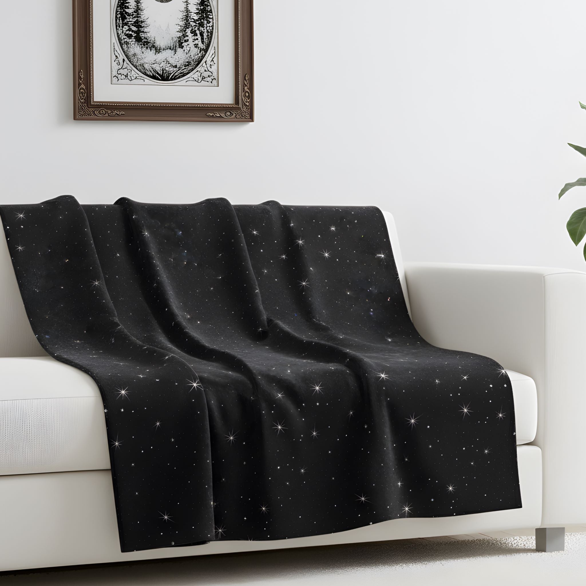 Black celestial velveteen throw blanket draped over a white sofa in a bright Gothic-inspired room.