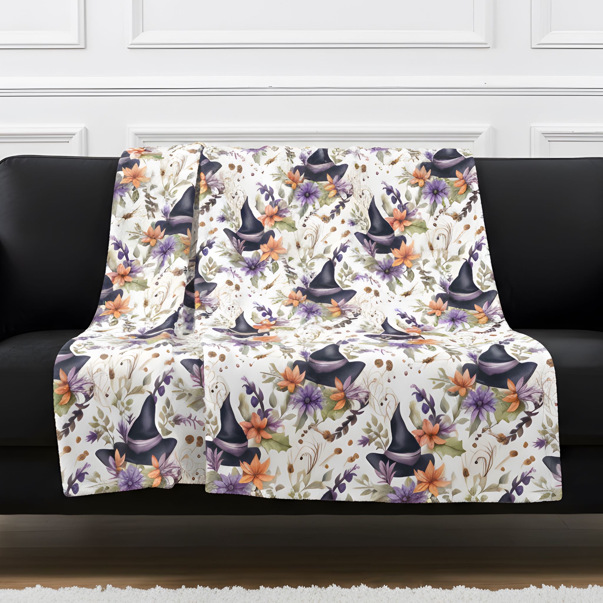 Whimsigoth witch hat throw blanket draped over a black sofa with floral print on ivory.
