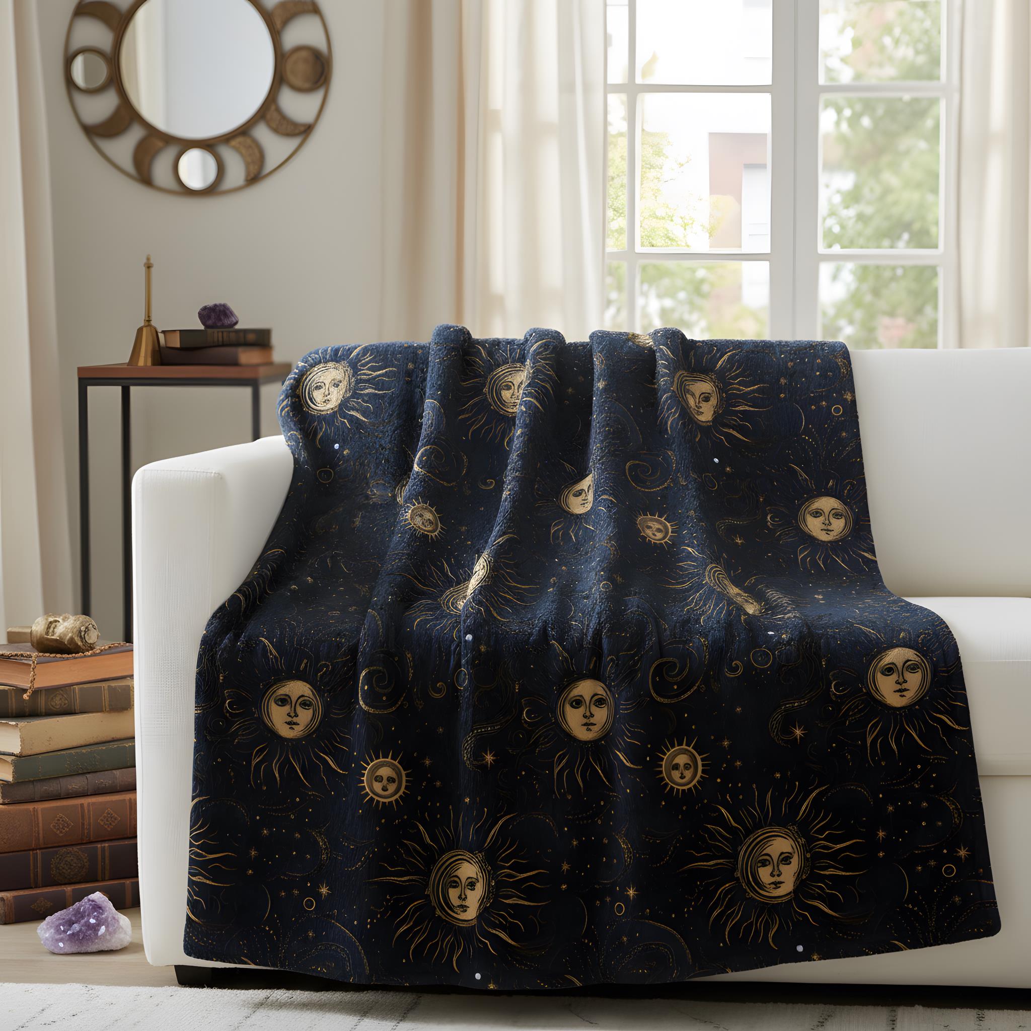 Golden celestial throw blanket thrown over a white couch in a whimsigoth living room.