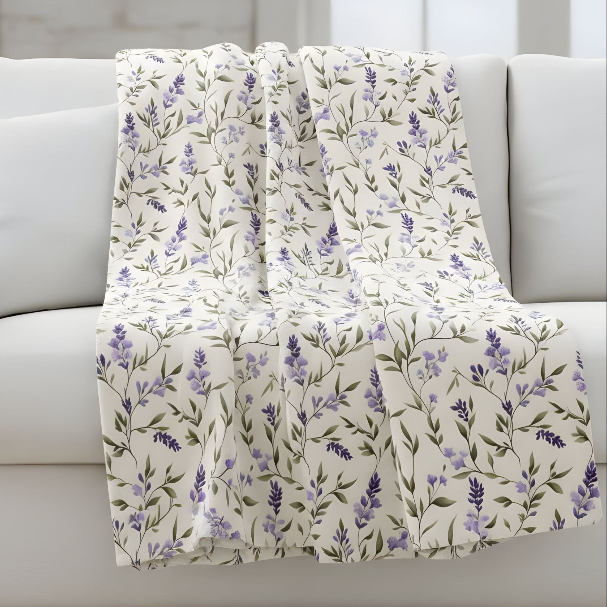 Lavender throw blanket draped over a gray sofa in a living room setting.