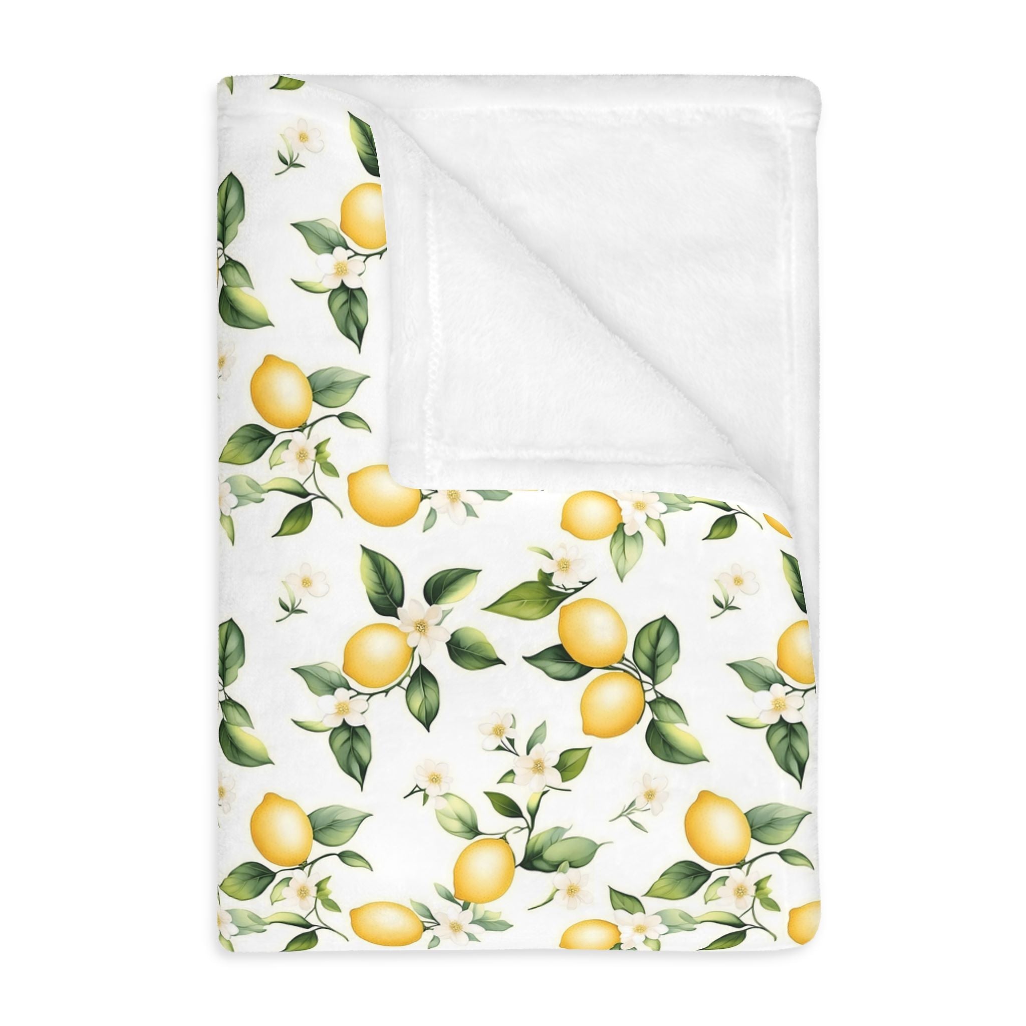 Folded Mediterranean style throw blanket with lemon and leaf pattern.