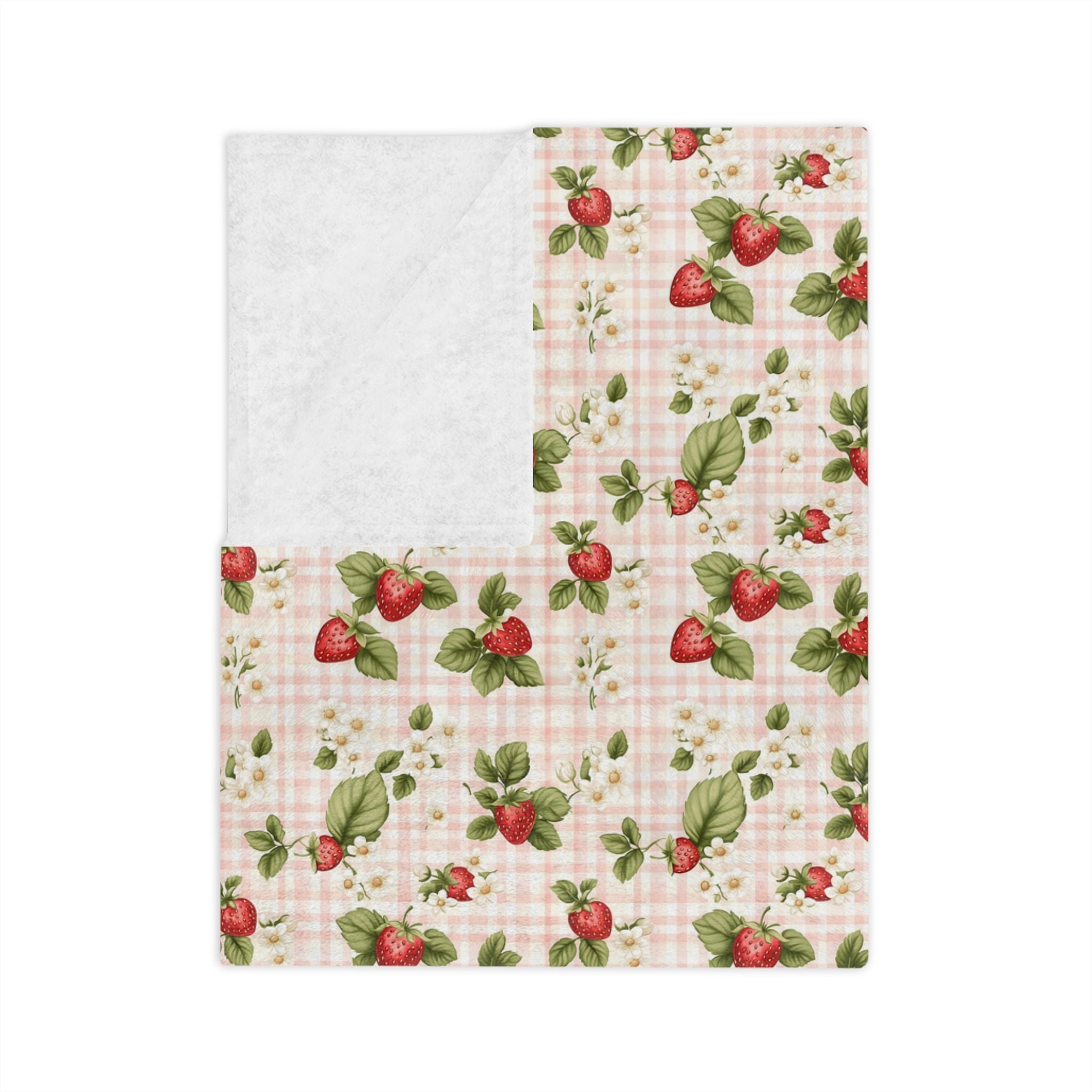 A strawberry pattern with a checkered background on a folded velveteen fabric.