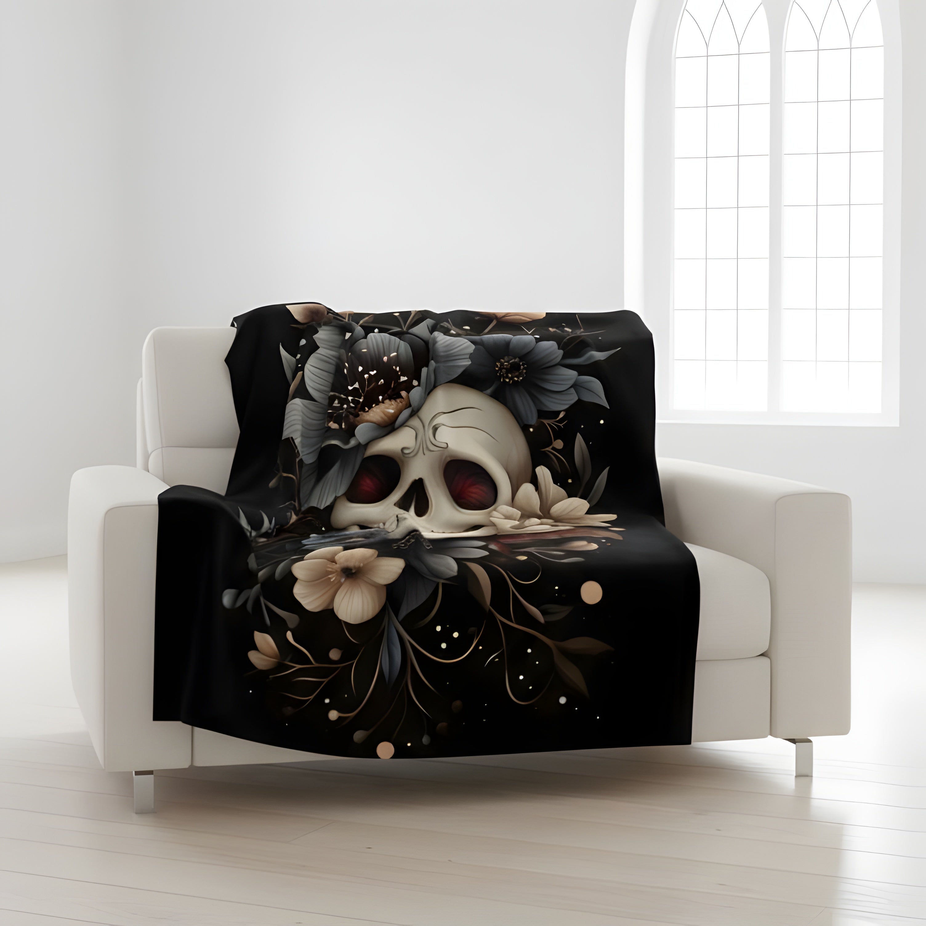Moody botanical skull throw blanket on white chair with dark floral design in lightweight velveteen fabric.