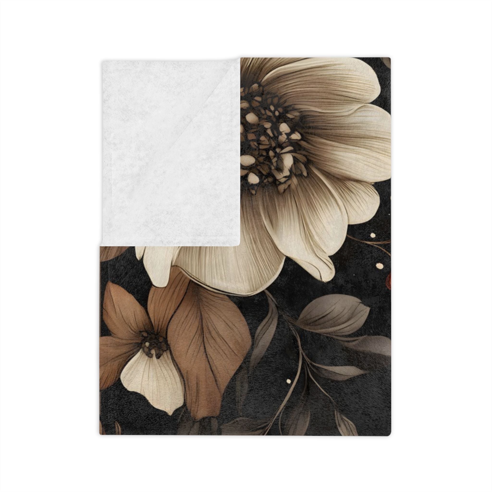 Folded black velveteen throw blanket with ivory flower, showing white backside.
