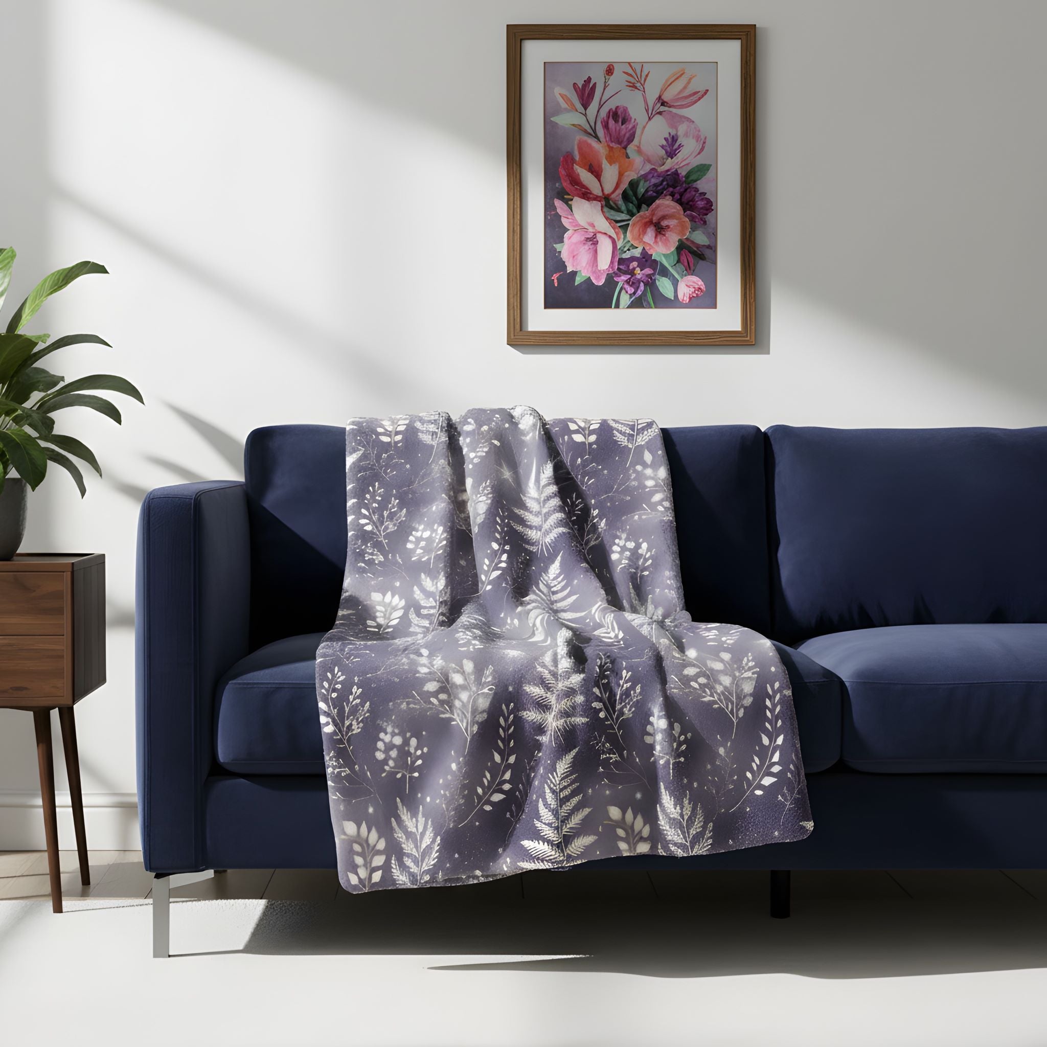 Lunar Ferns velveteen blanket styled on a navy sofa in a moody Gothic living room.