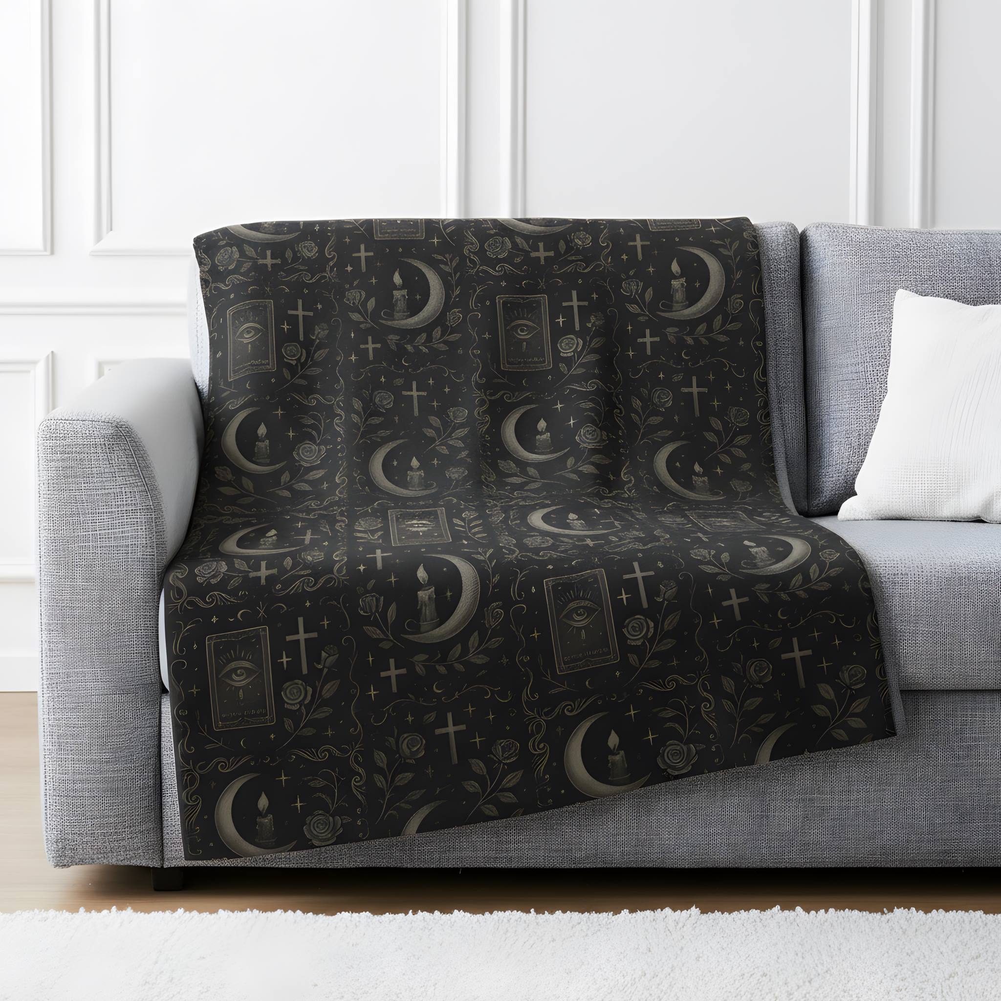 Whimsigoth velveteen throw blanket draped over a gray sofa with mystical celestial print.