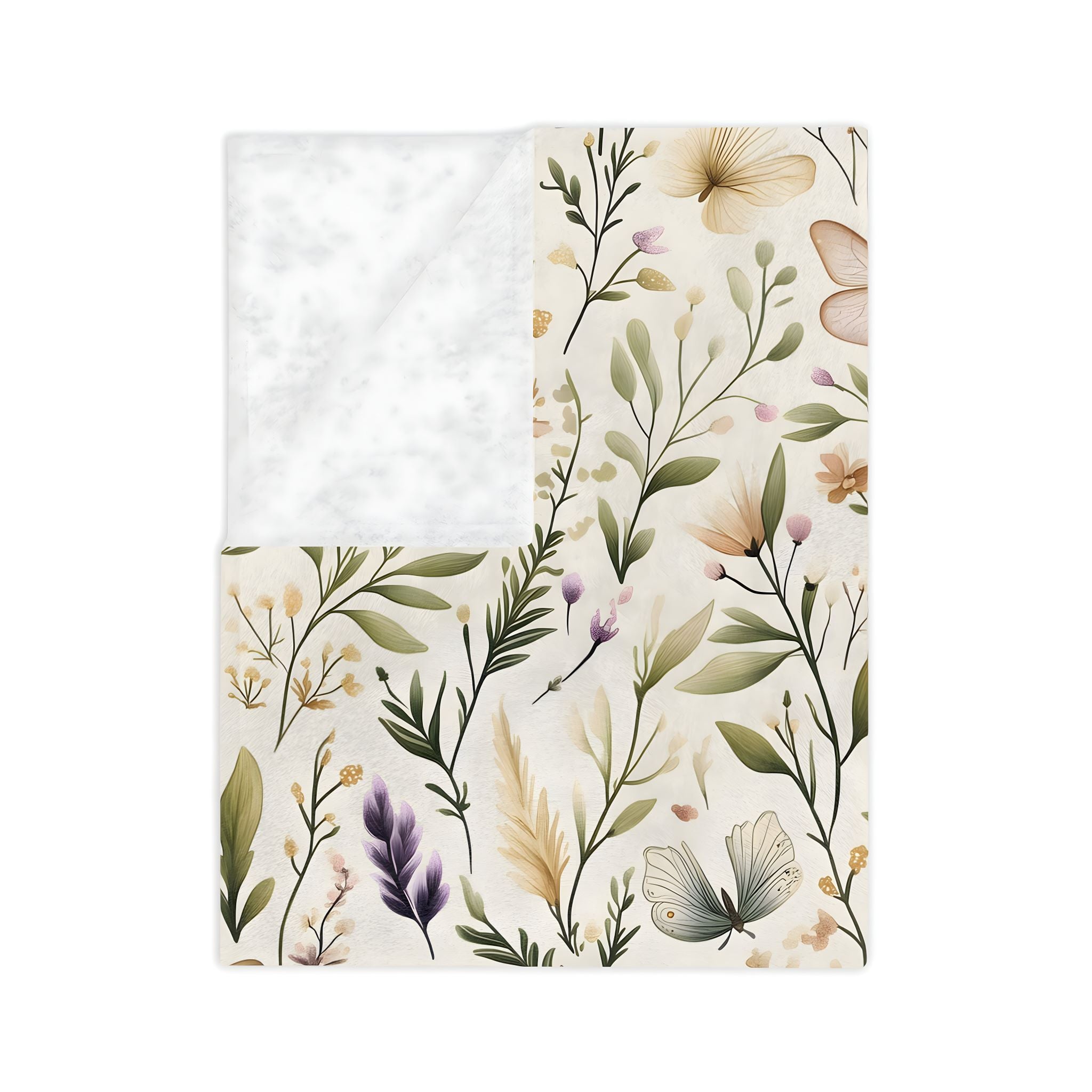 A folded floral and butterfly blanket with leaves and flowers.