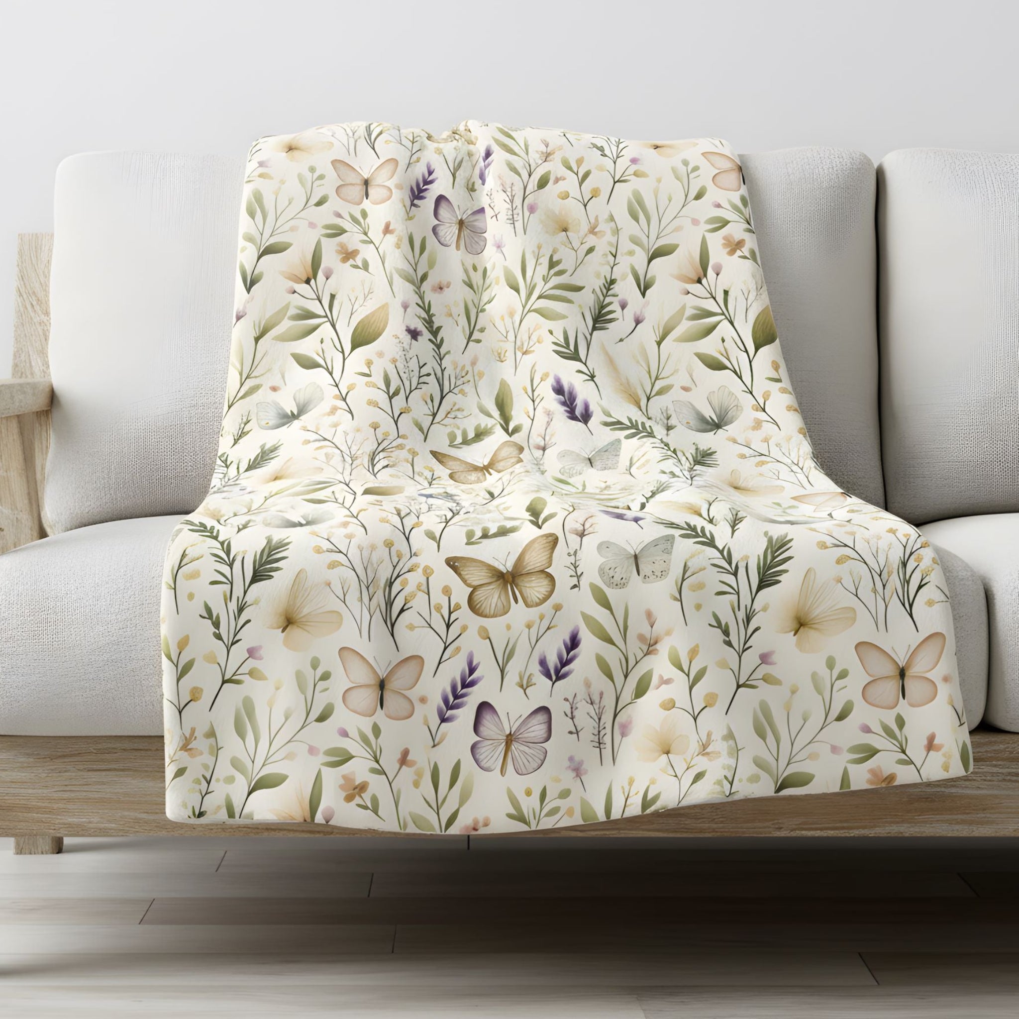 Floral and butterfly patterned blanket draped over a sofa in a living room setting.