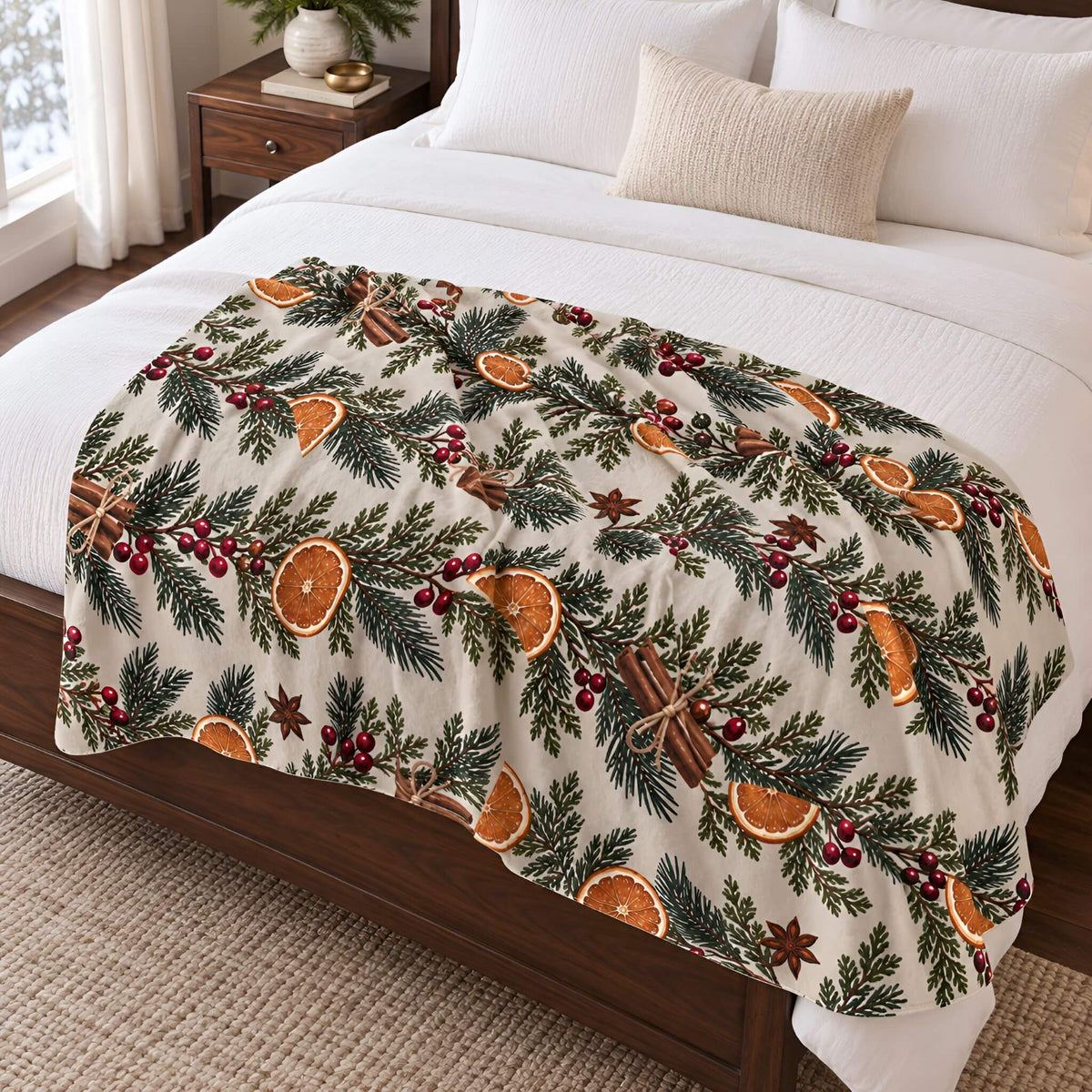 Orange and evergreen sherpa throw blanket spread across a bed with white bedding.