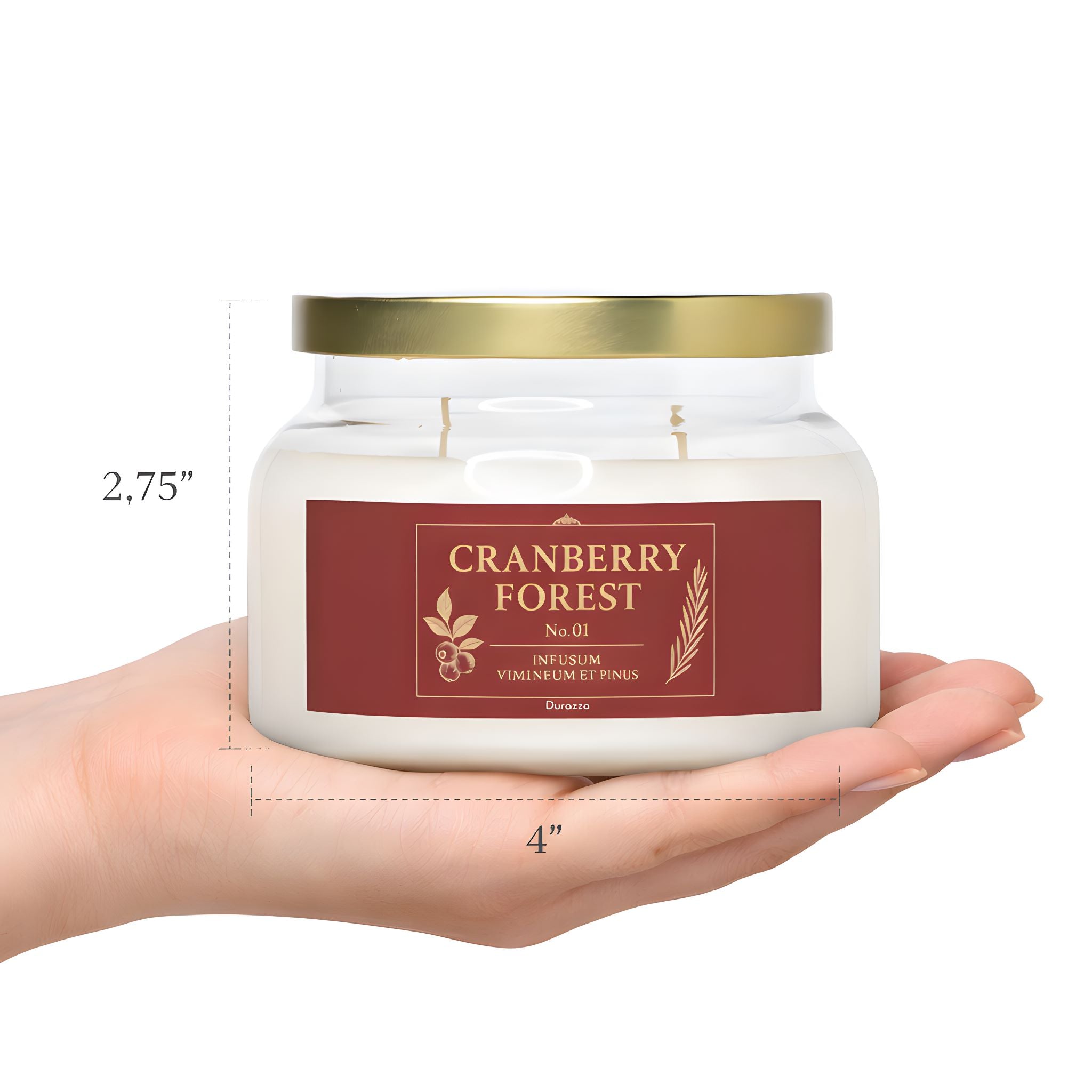 A person's hand holding a cranberry pine winter candle showing the actual product size.