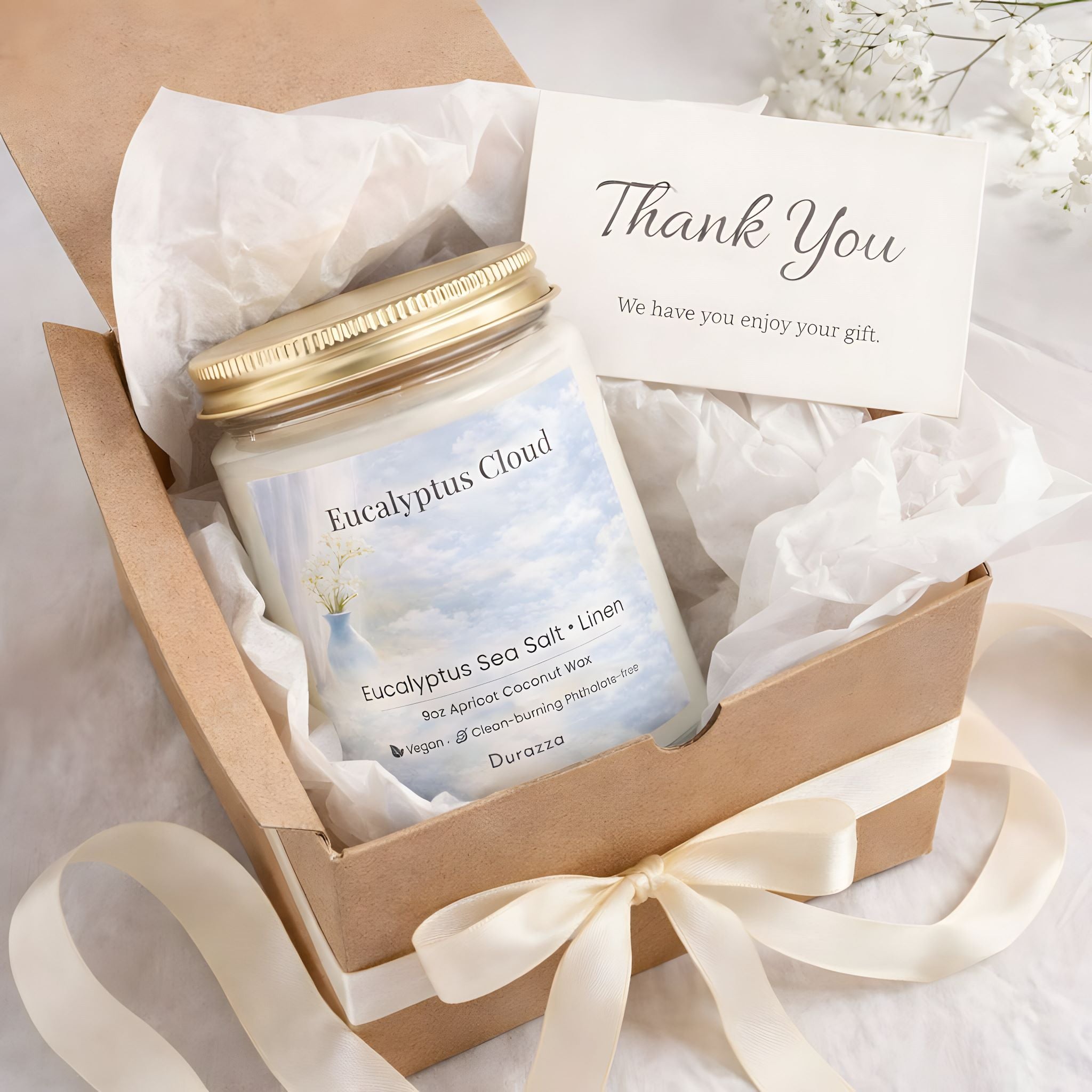 Gift box with a summer sea salt scented candle labeled 'Eucalyptus Cloud' and a 'Thank You' card on a light background.
