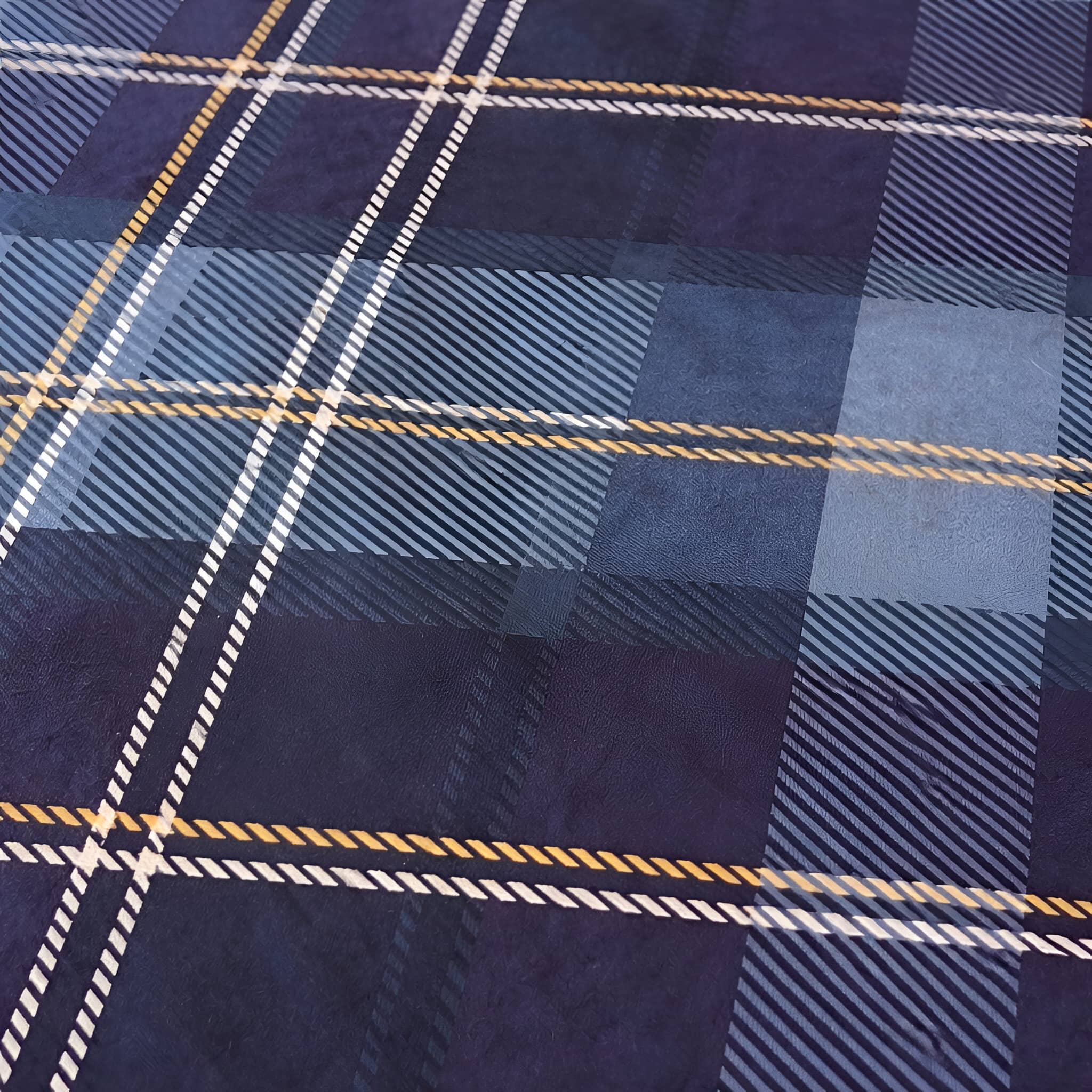 Close-up of a blue plaid duvet fabric with white and gold lines