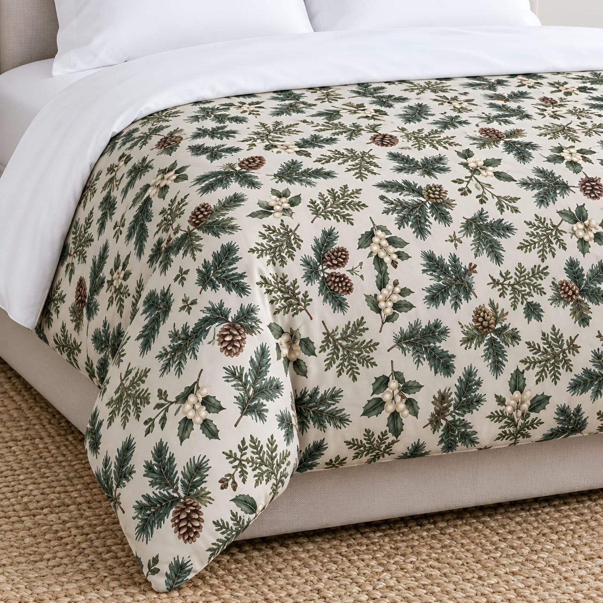 A holiday-themed duvet cover with a green pine and holly pinecone pattern on a cream background, styled on a bed with white sheets.