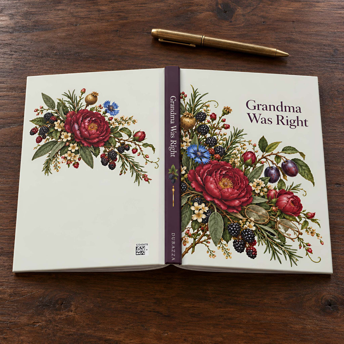 An open hardcover notebook titled "Grandma Was Right" lies on a dark wooden tabletop, with a gold pen placed above it. The cover and spine feature a large vintage-style floral illustration with red roses, blackberries, blue flowers, and green foliage on an off-white background.