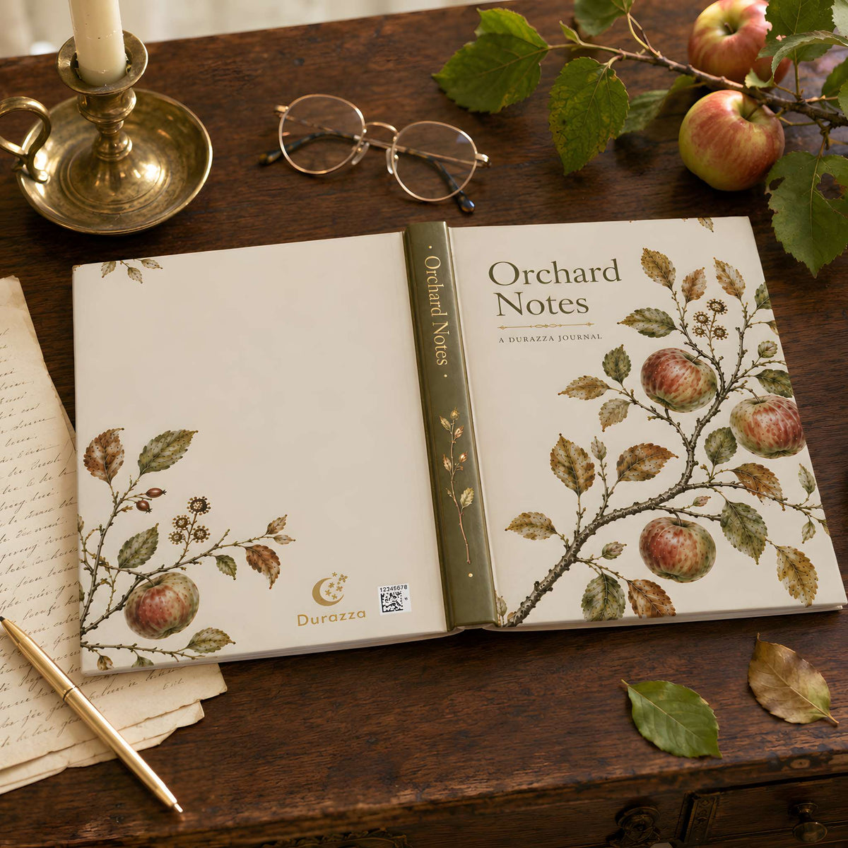 An opened 'Orchard Notes' journal lies on a rustic wooden table, surrounded by vintage-style props including a brass candlestick, eyeglasses, apples, and a gold pen. The journal cover and interior pages feature delicate botanical illustrations of apples and leaves.