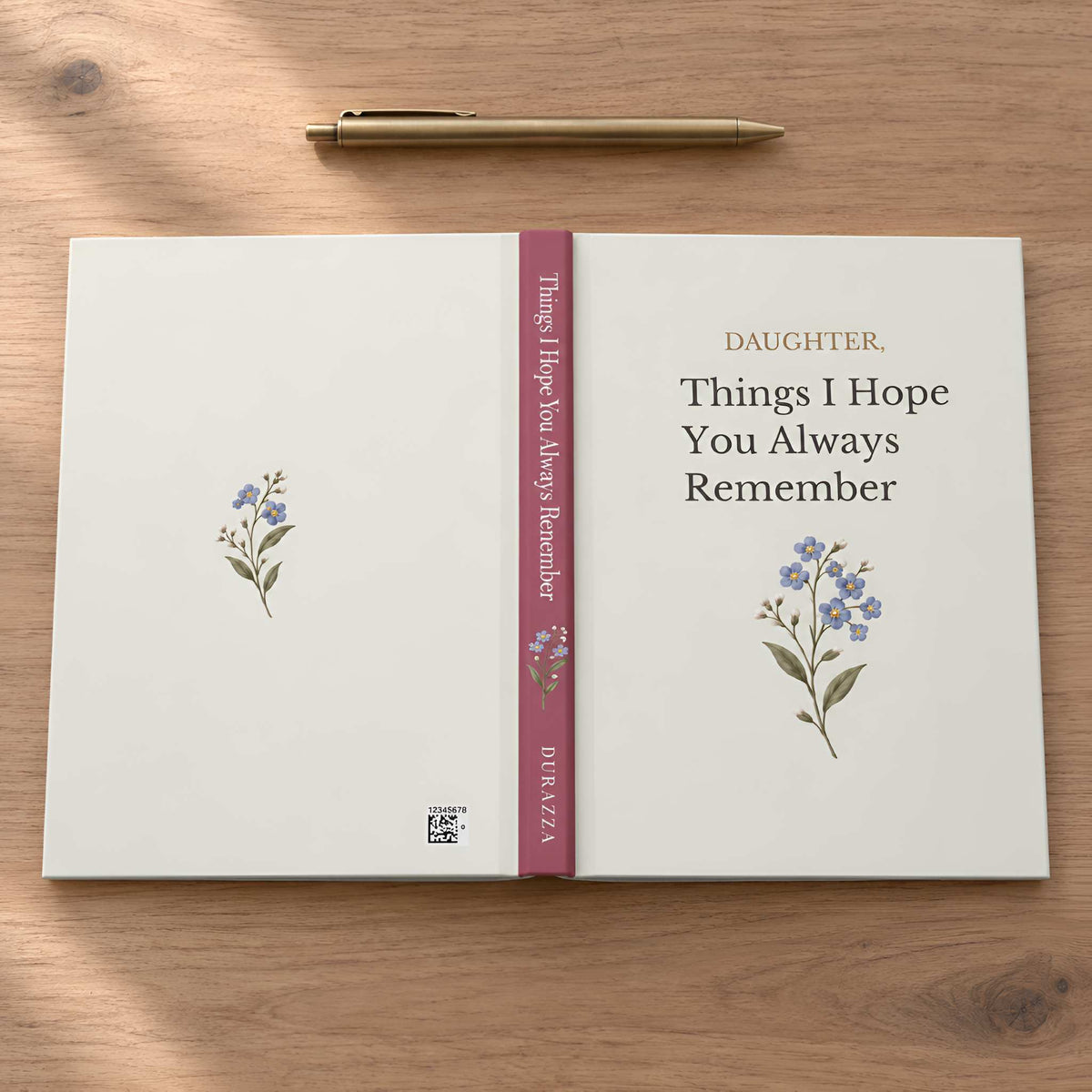 A daughter journal titled 'Things I Hope You Always Remember' for 'DAUGHTER,' laid open on a wooden tabletop with a gold pen above it. The cover is warm off-white with a vertical dusty rose spine band and small blue floral illustrations.