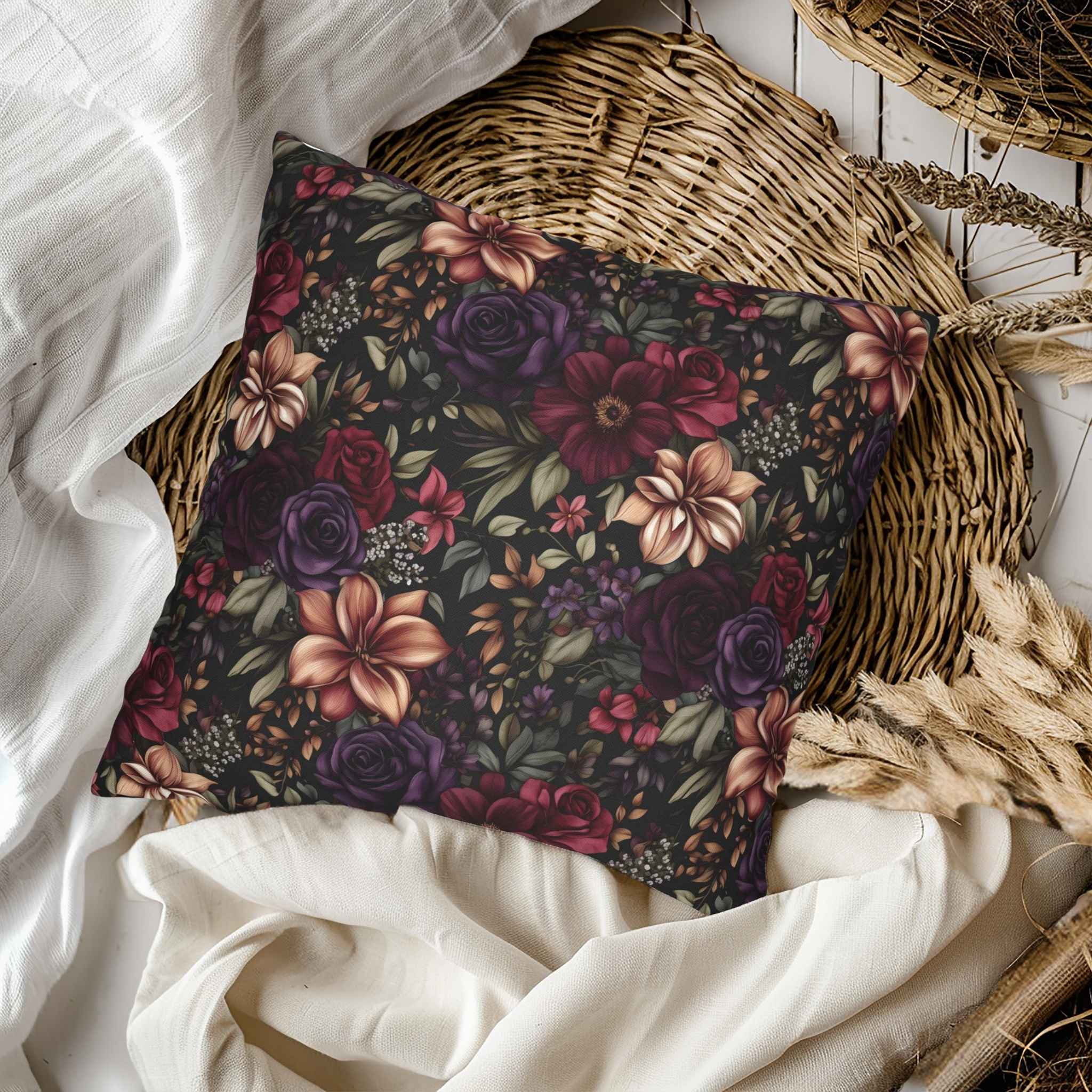 Floral-patterned pillow on a bed with white bedding and wicker basket.