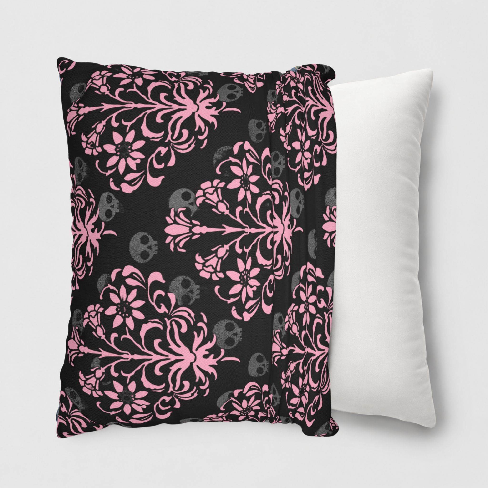 Pink damask skull pillow cover being slipped onto a throw pillow.