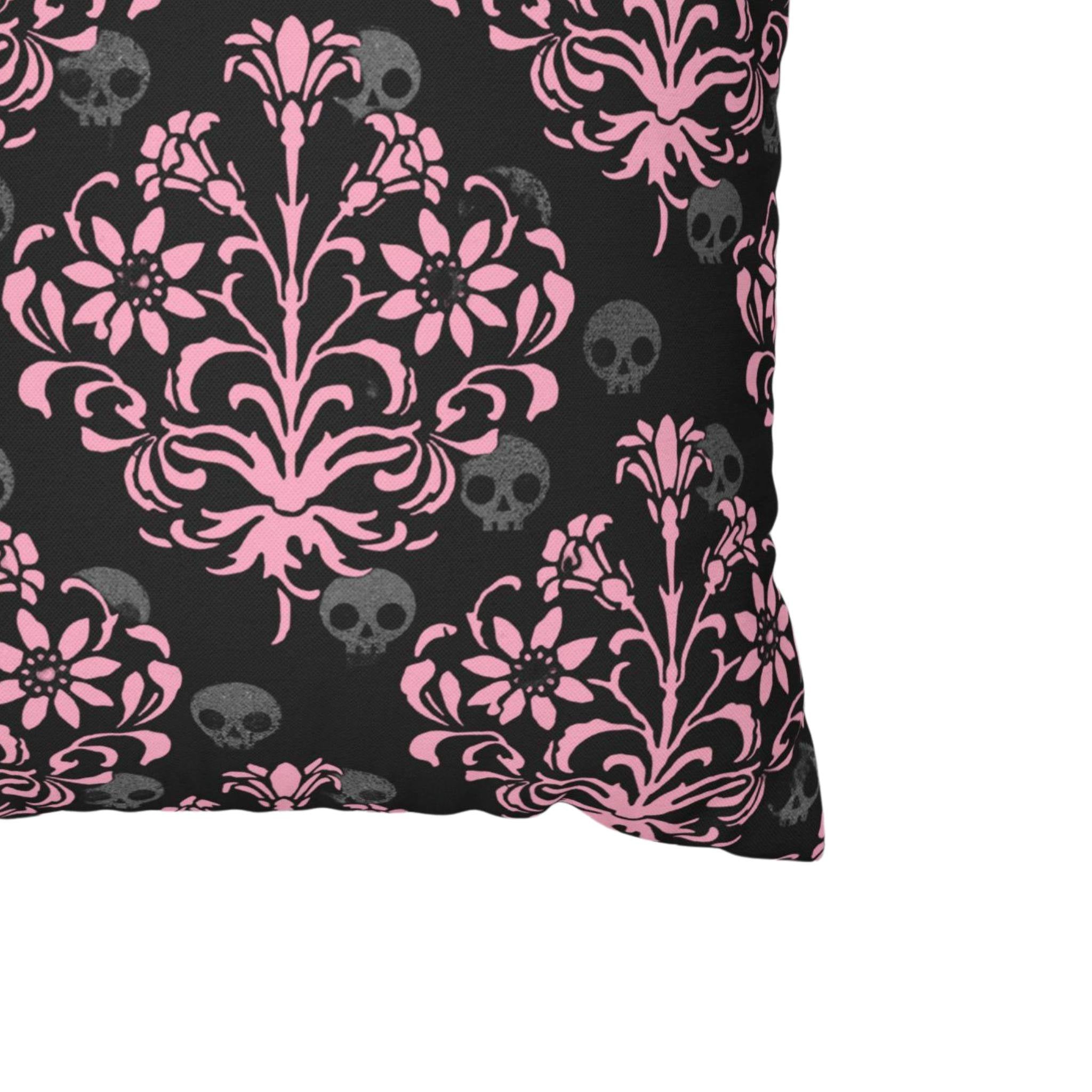 Close-up of pink skull damask pillow cover with gray skull details