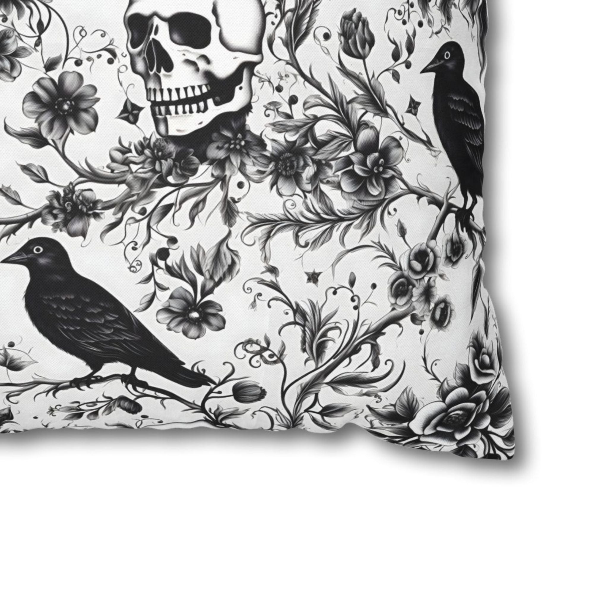 Close-up of black and white raven skull floral pillow cover pattern on polyester fabric.