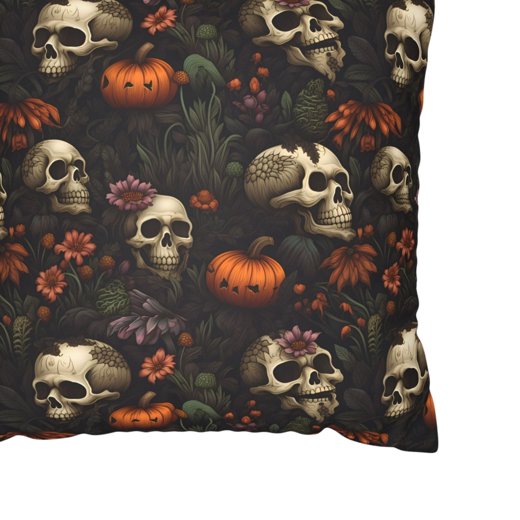 Close-up of skull pumpkin pillow cover with orange pumpkins and dark florals.