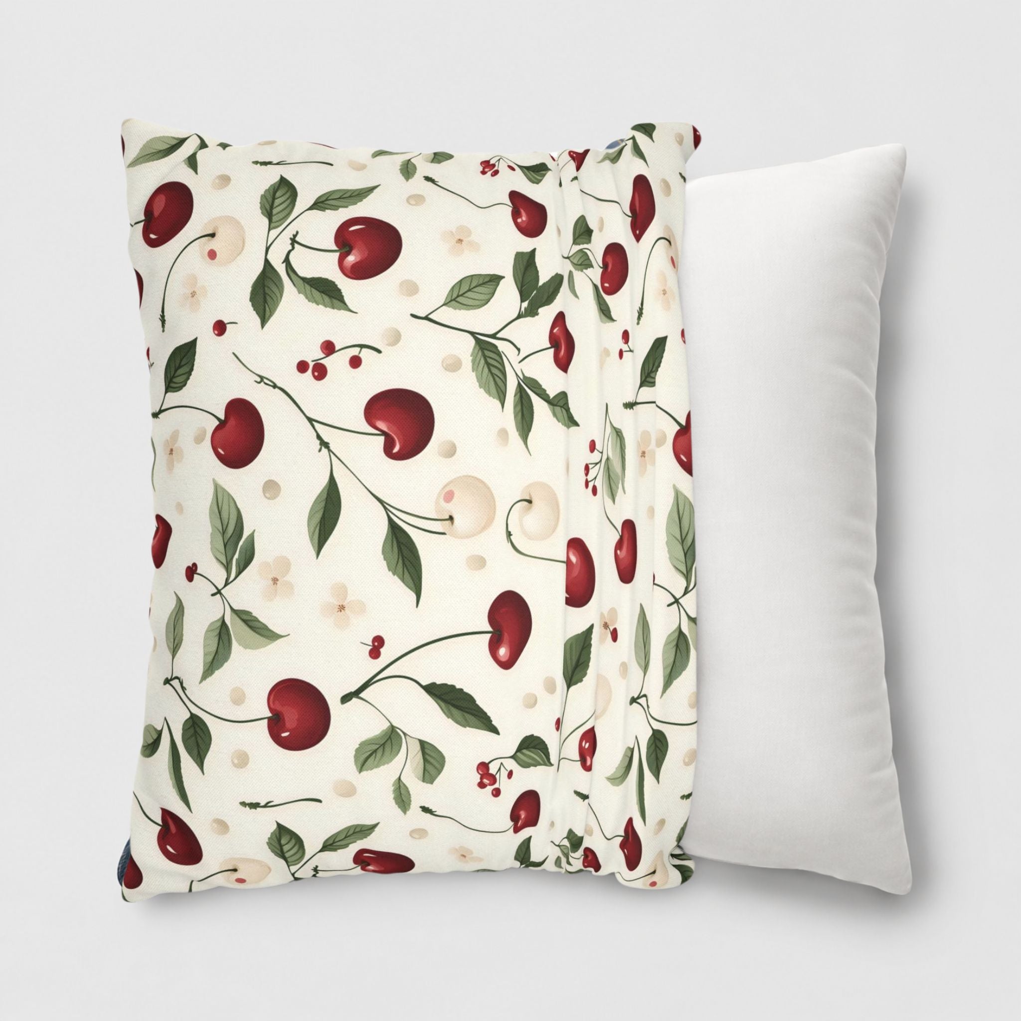 A white and red cherry pillow cover being slipped onto a 20-inch throw pillow.