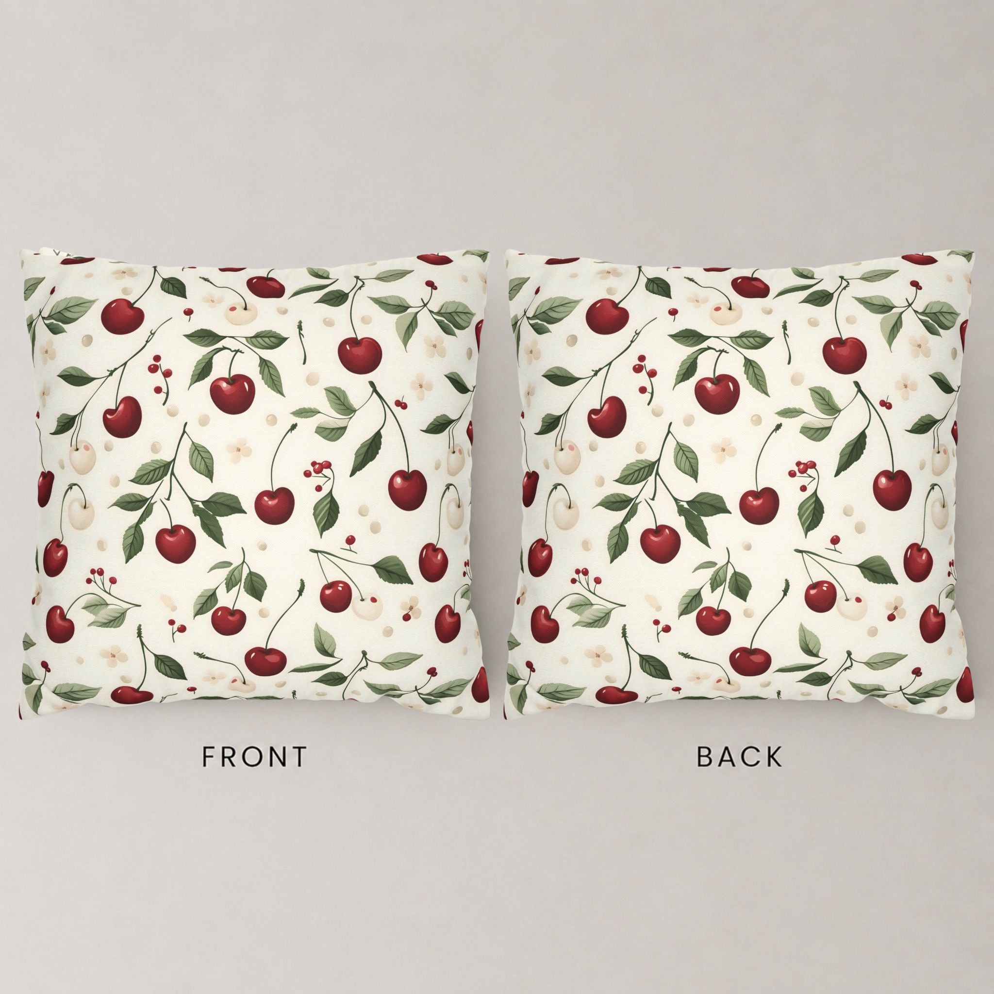 Front and backside of a pillow cover showing a red and white cherry pattern with leaves.