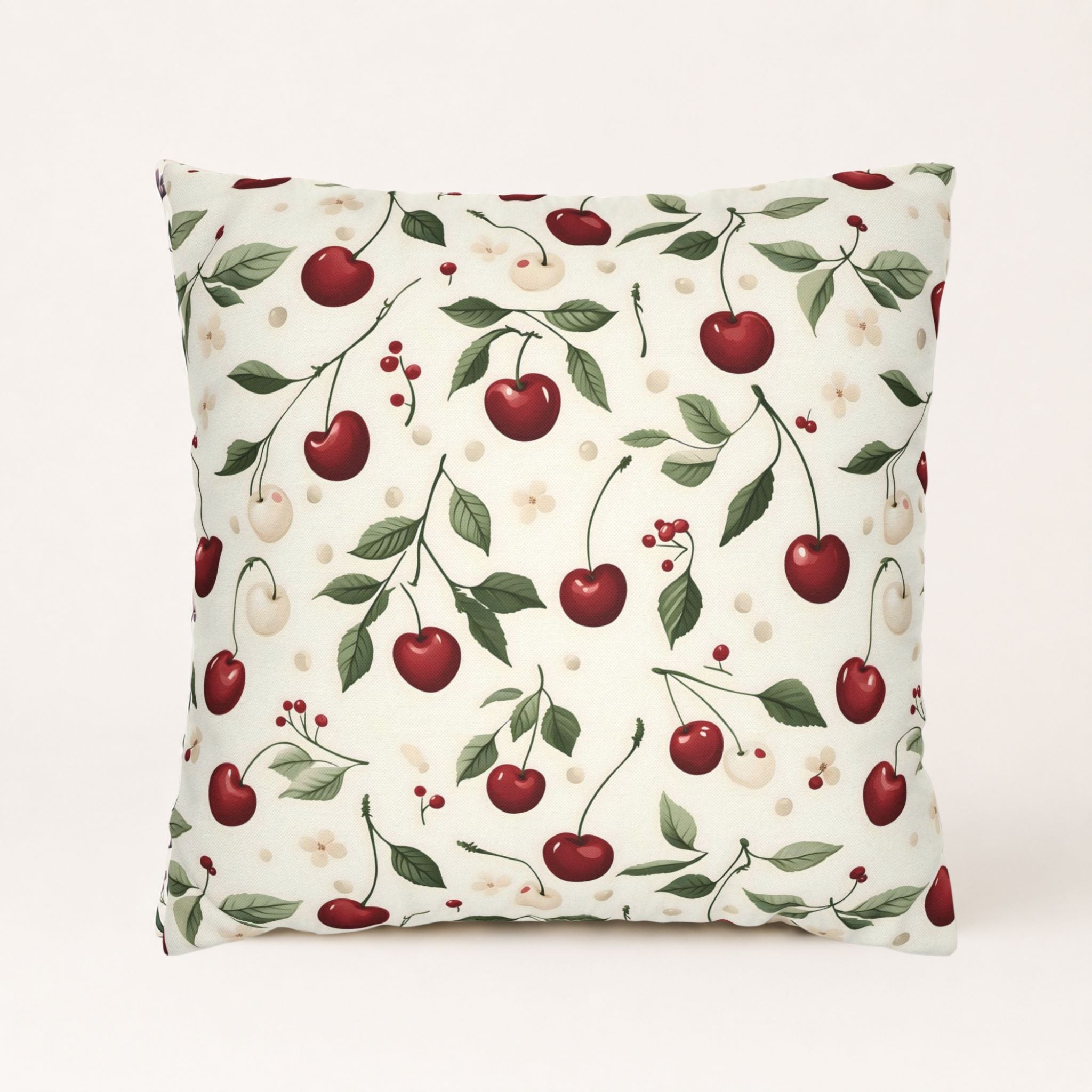 Cherry botanical throw pillow on a cream background.