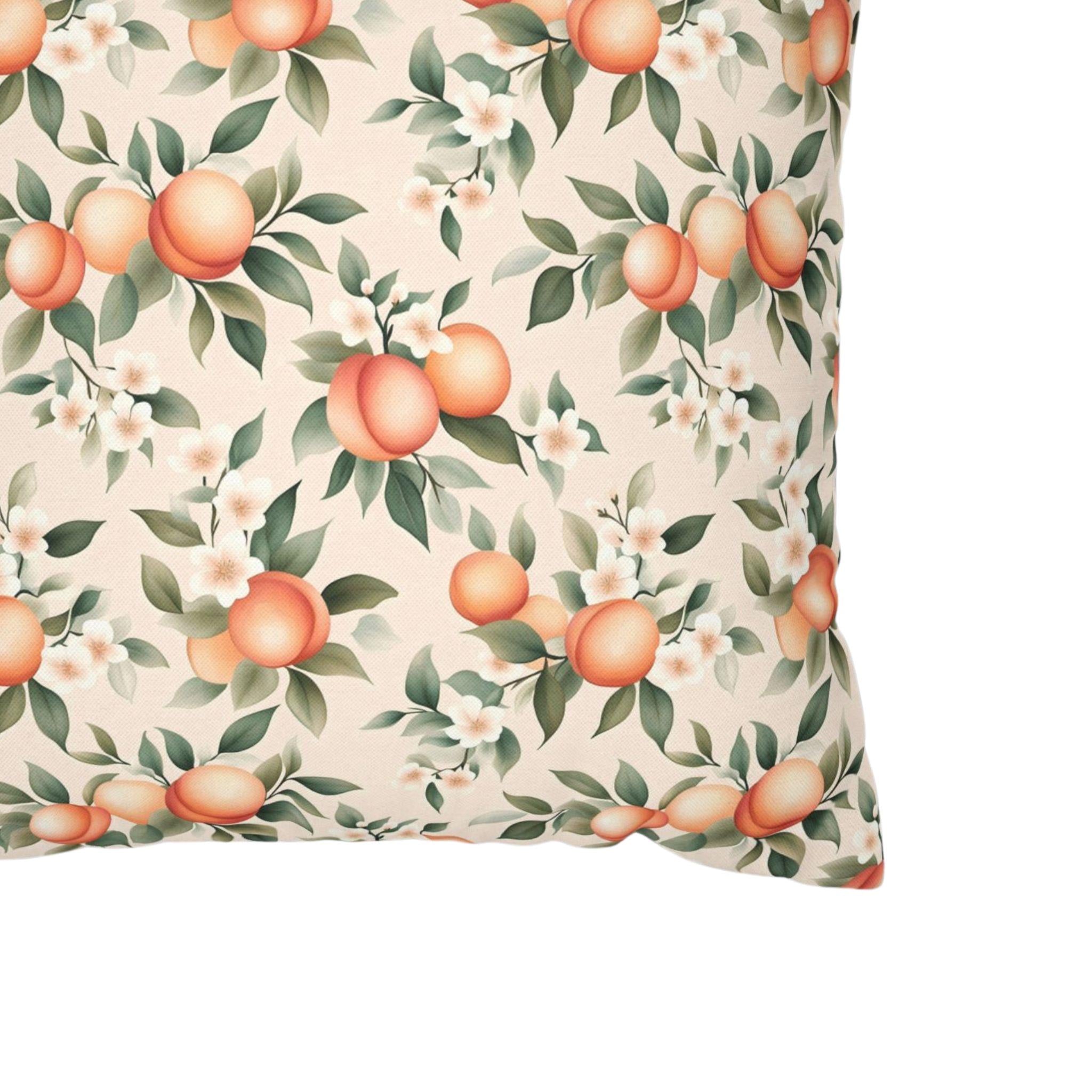 A close up of a peach pillow cover showing white blossoms.