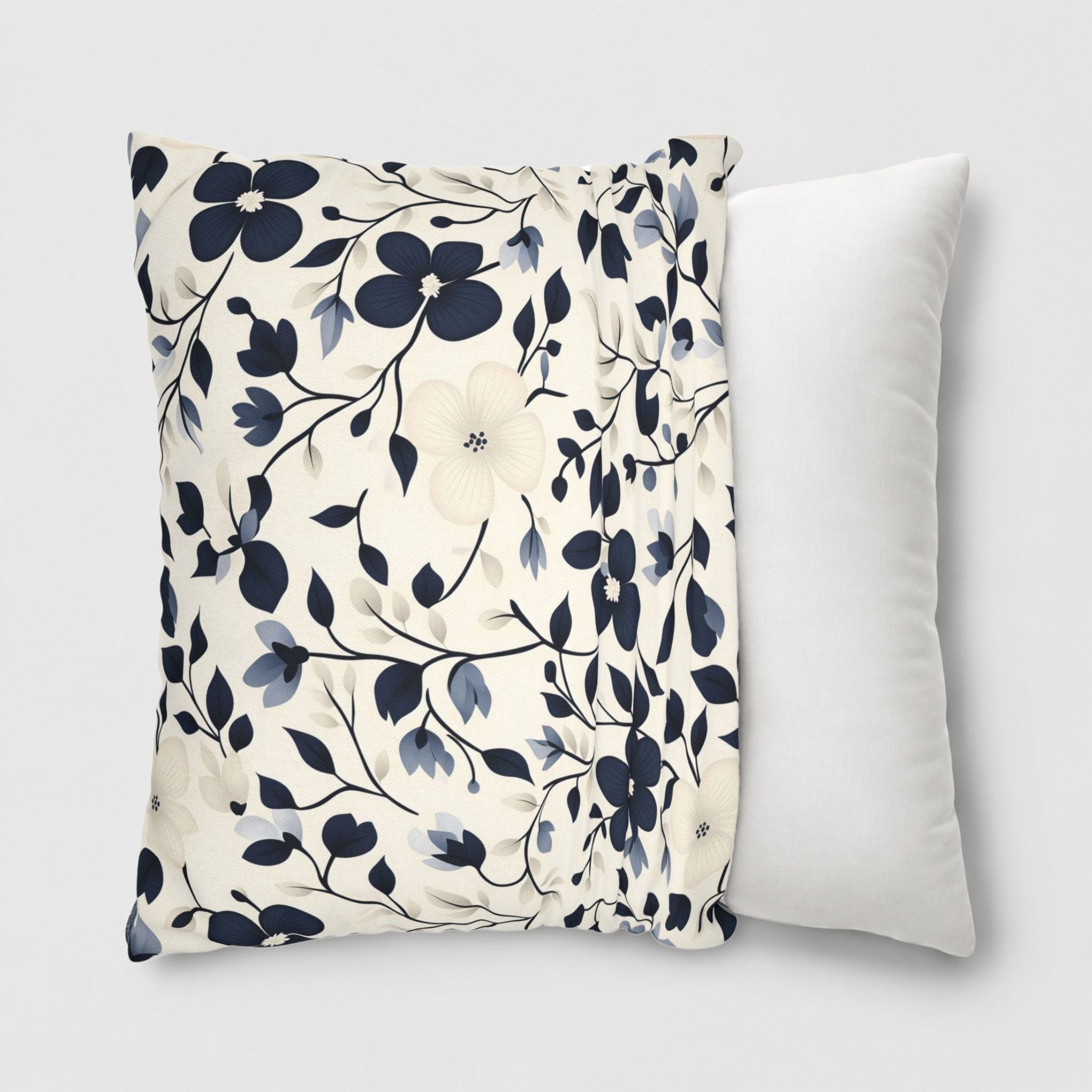 Navy floral pillow cover in 18 inch being slipped onto a 20 inch throw pillow.