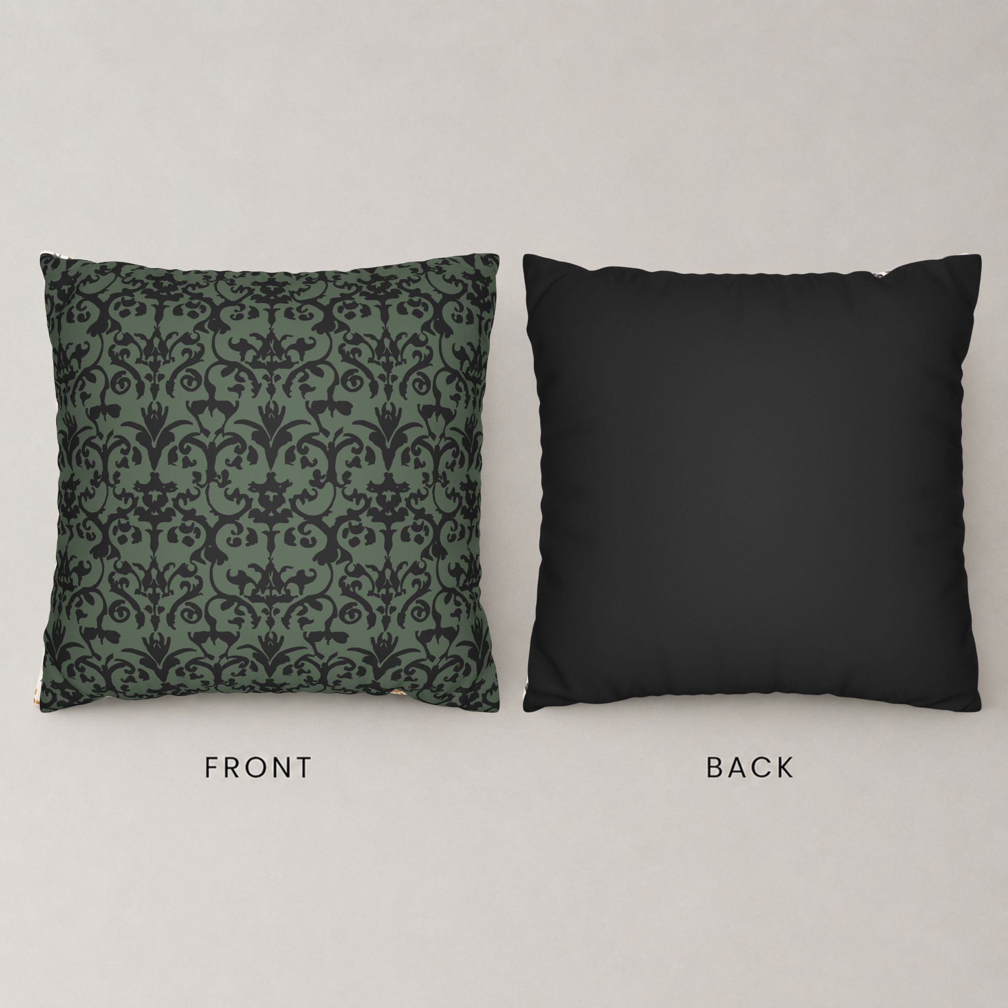 Front of throw pillow with green and black damask design, with a solid black backside.
