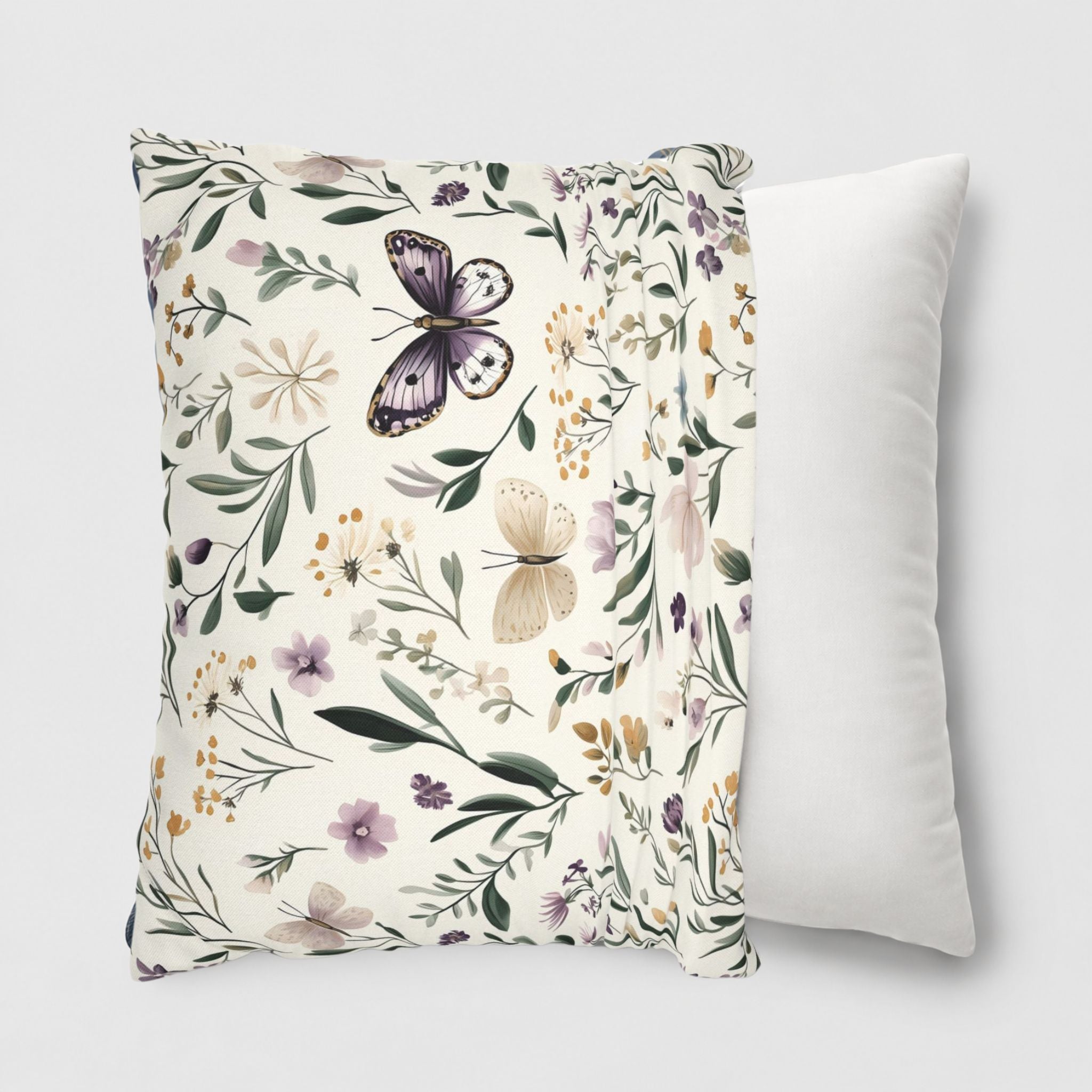 Cottage styled pillow cover with a butterfly and flowers being slipped onto a throw pillow.