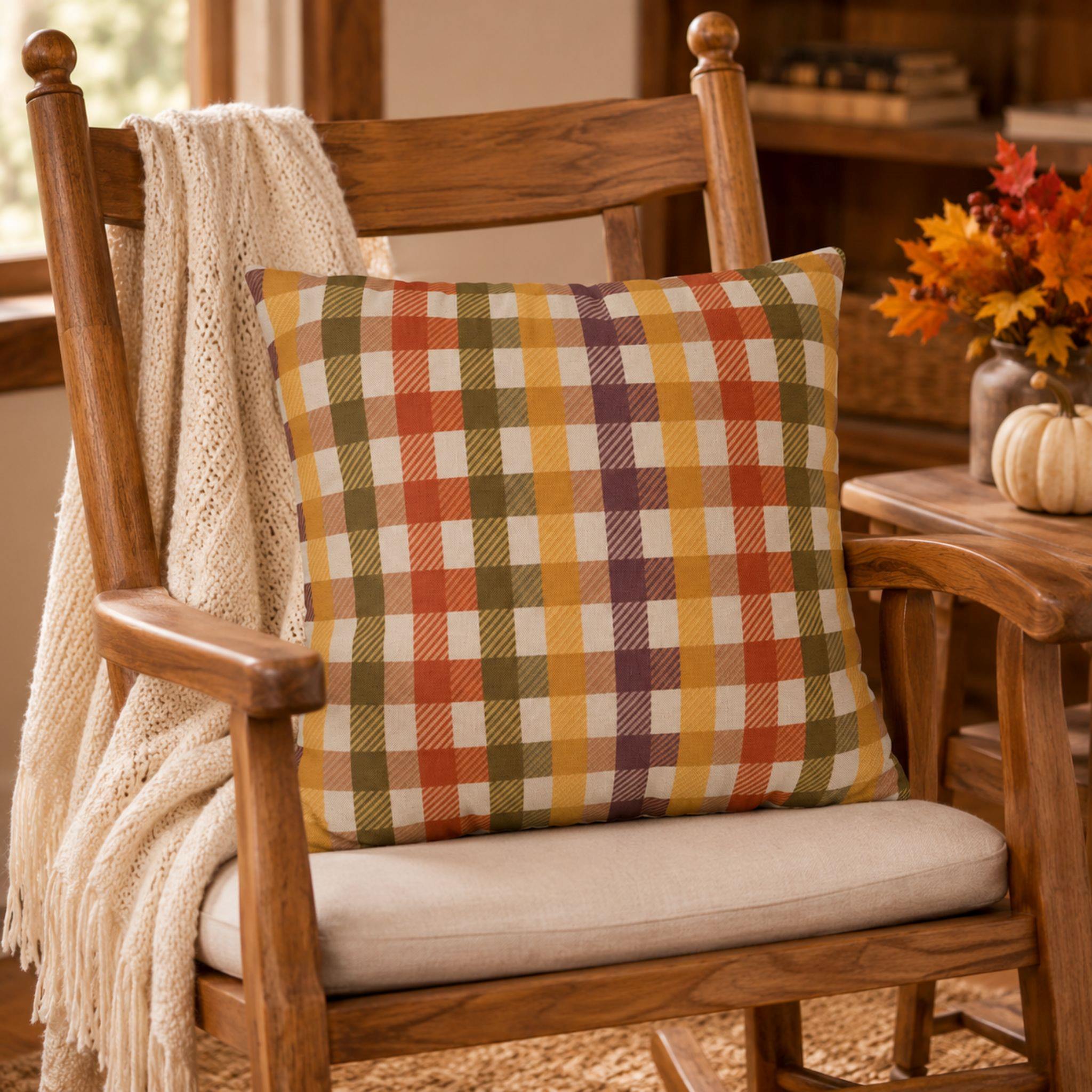 Wooden chair with an Autumn tartan pillow cover and blanket in a cozy room.
