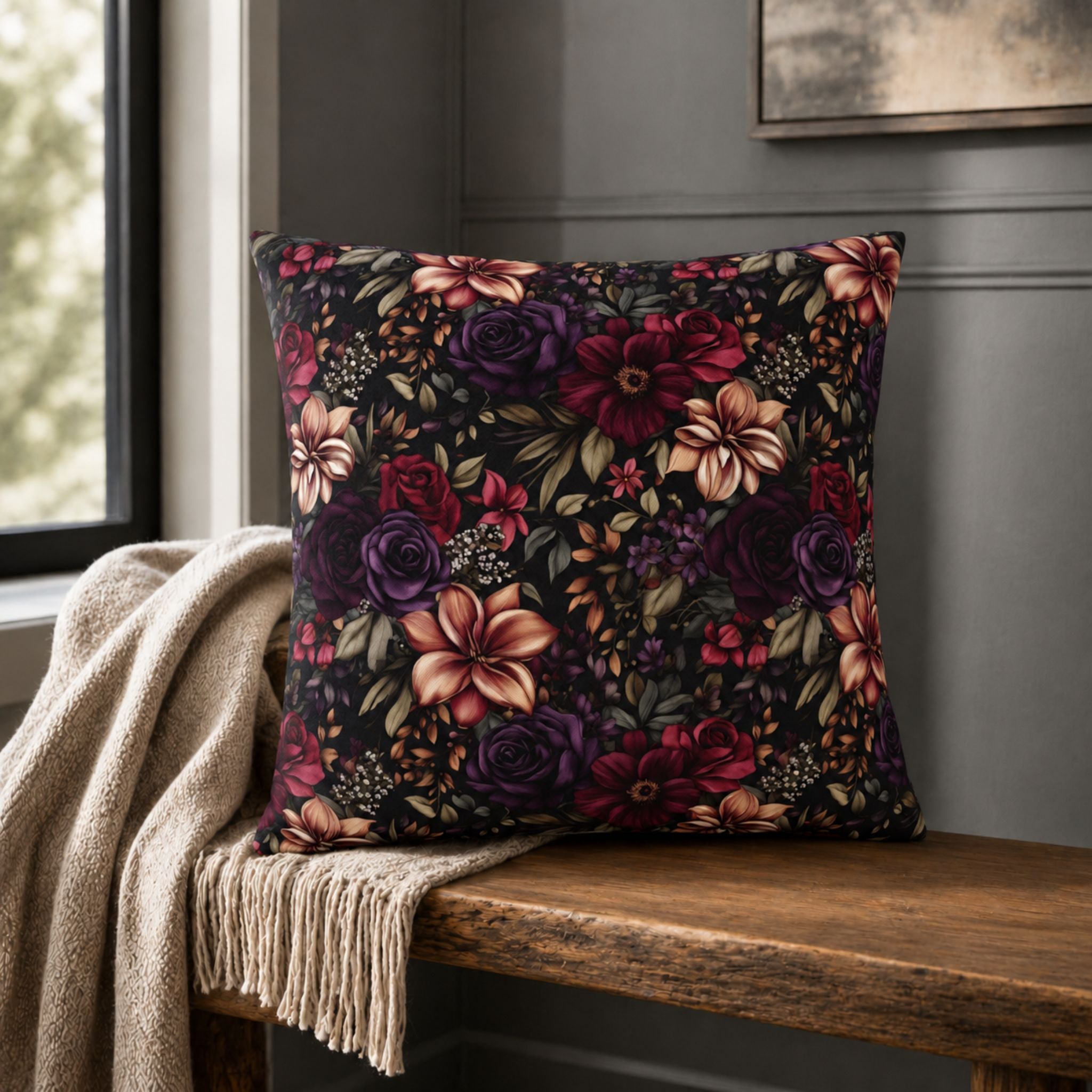 Floral pillow cover on a wooden bench against a gray wall.
