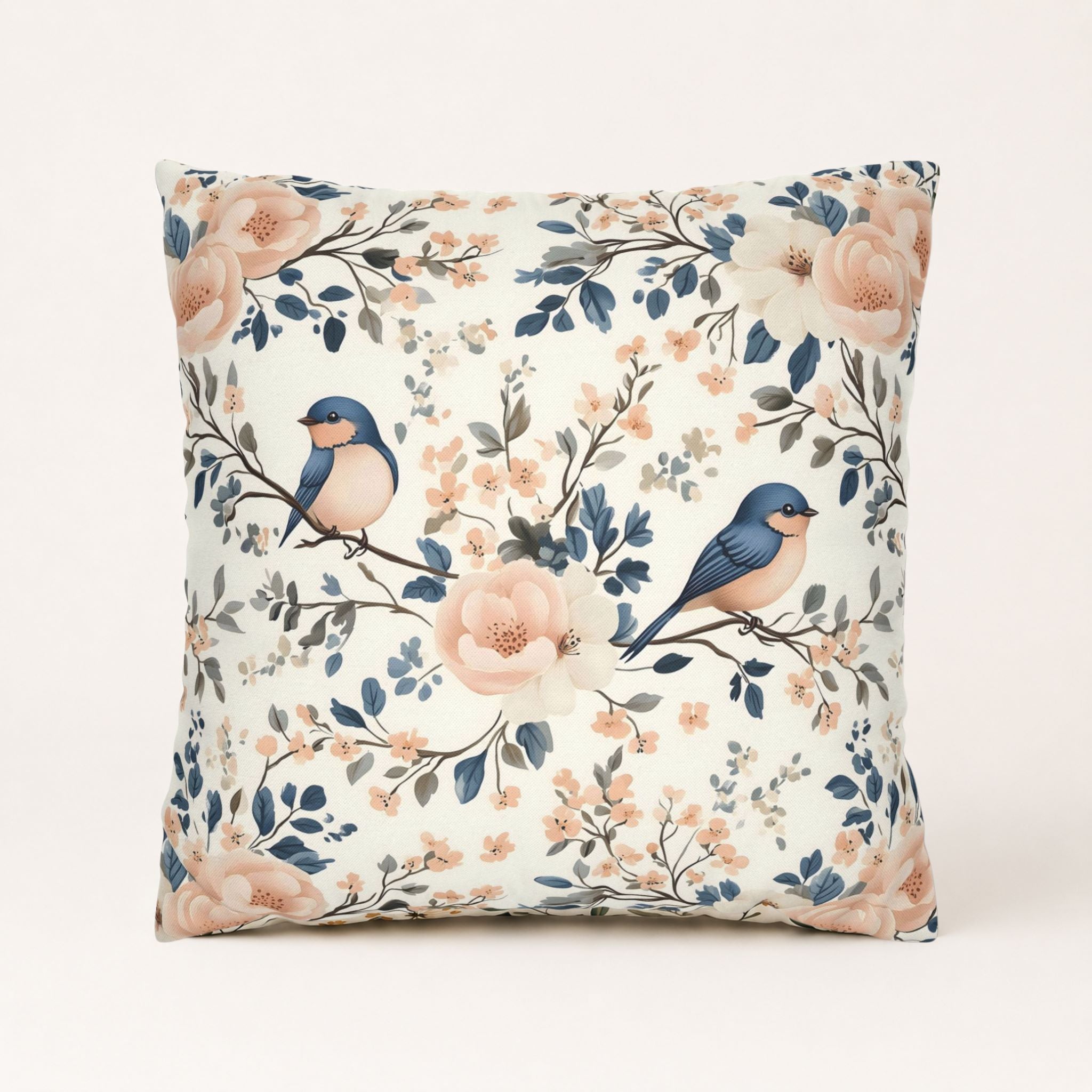 Blue birds and pink flowers on a square polyester pillow cover.