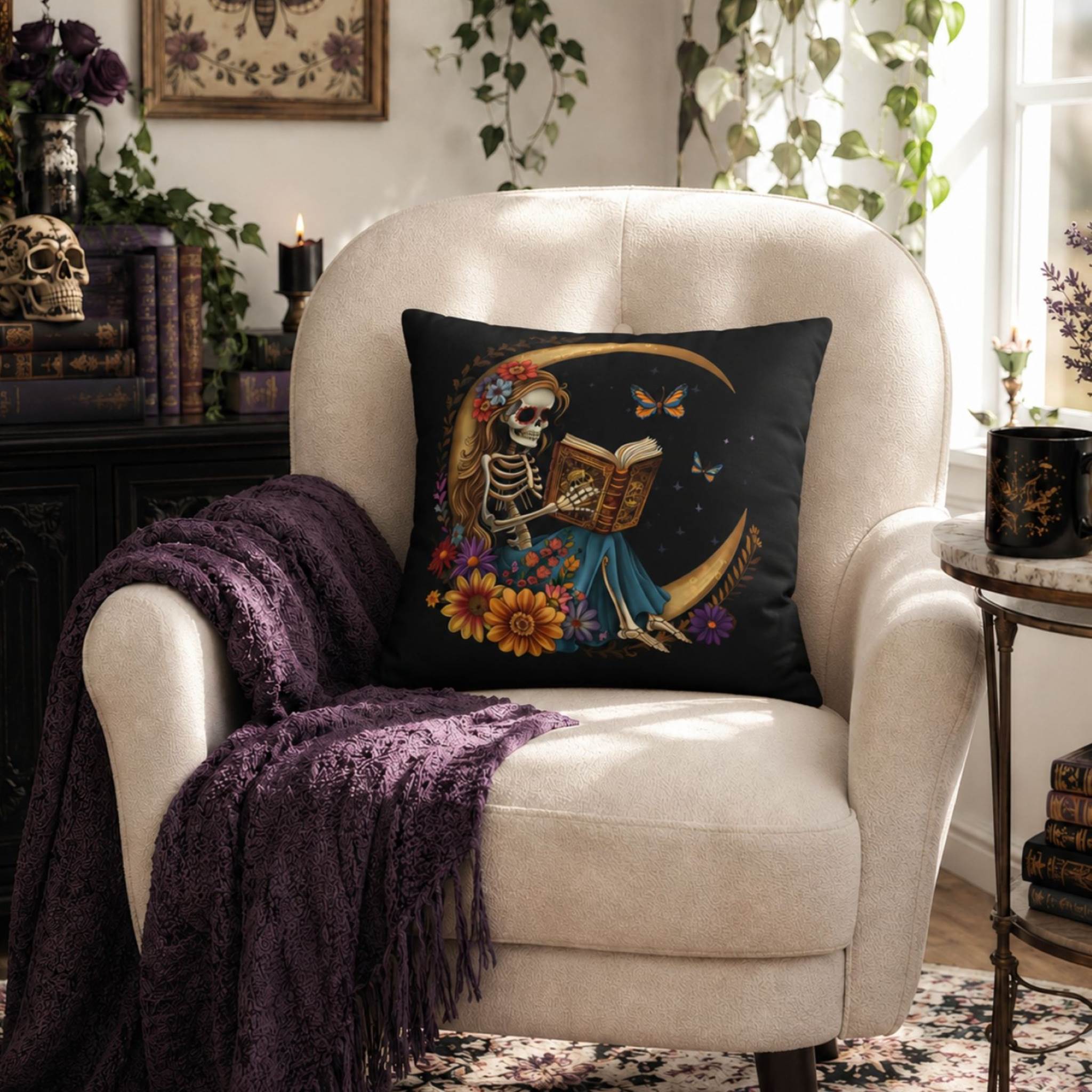 Skeleton moon pillow cover styled on cream chair with dark throw blanket for whimsigoth home styling.