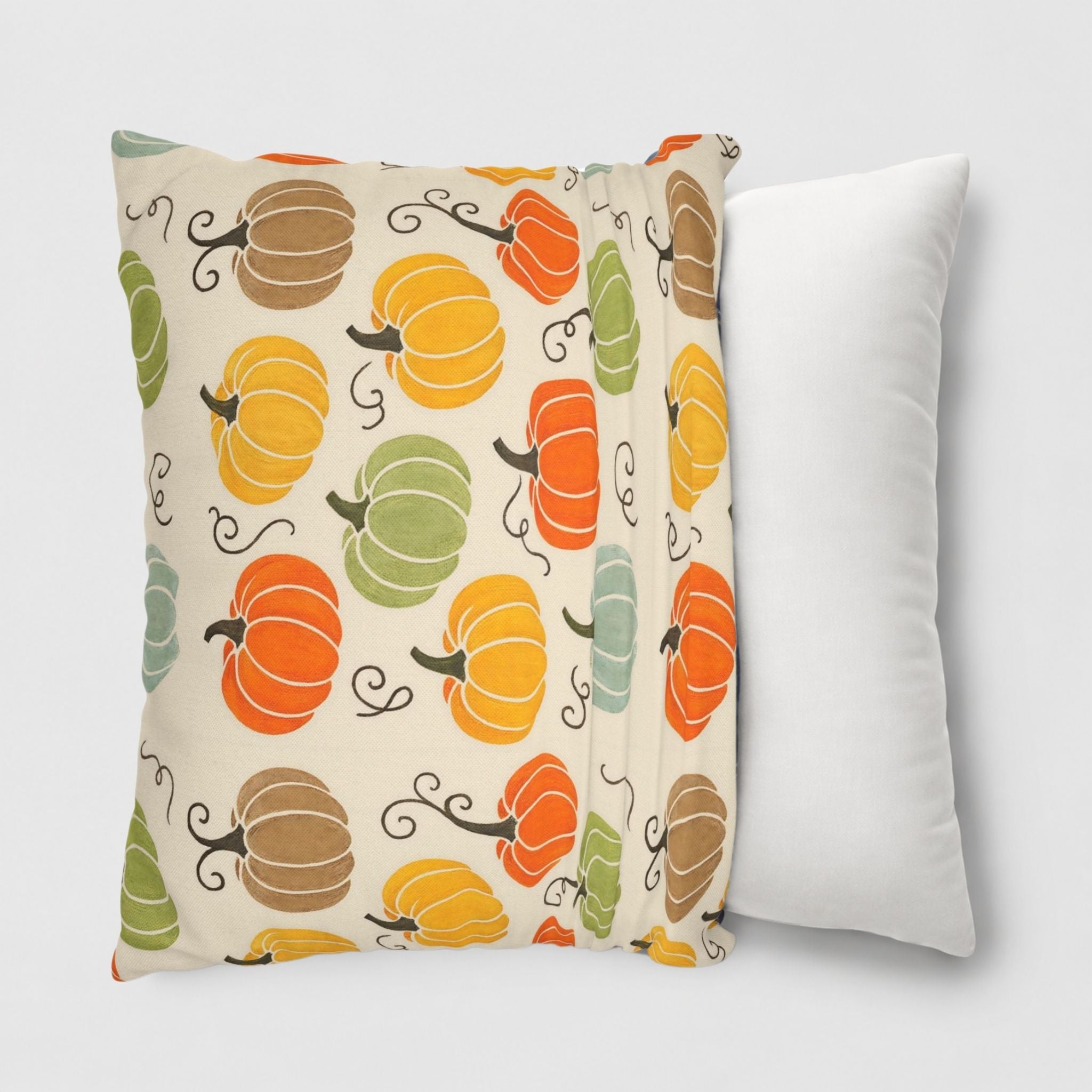 Fall pillow cover with orange, yellow, green, and blue pumpkins being slipped onto a 18 inch throw pillow.