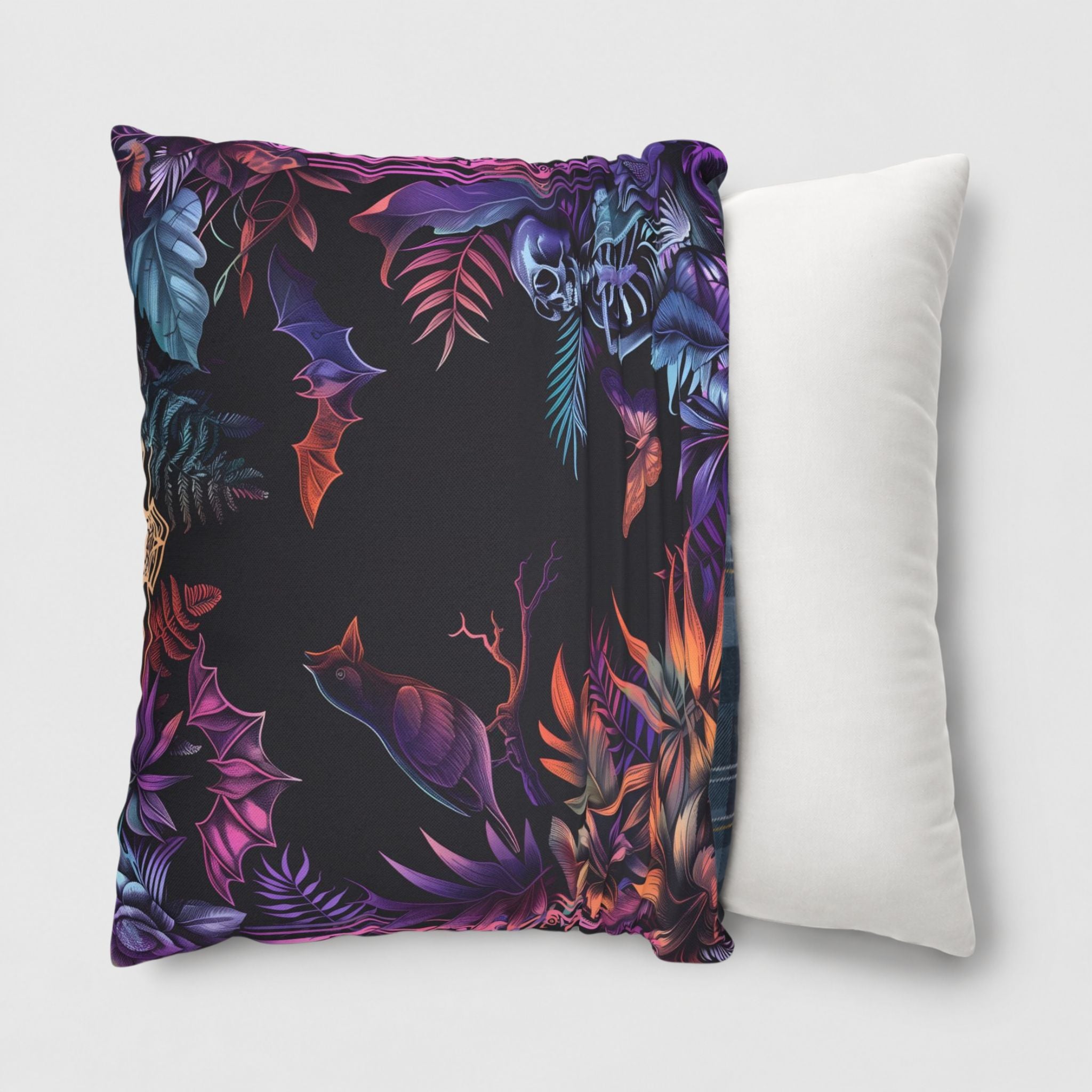 Black pillow cover with a colorful nature-themed pattern being slipped onto a throw pillow insert.