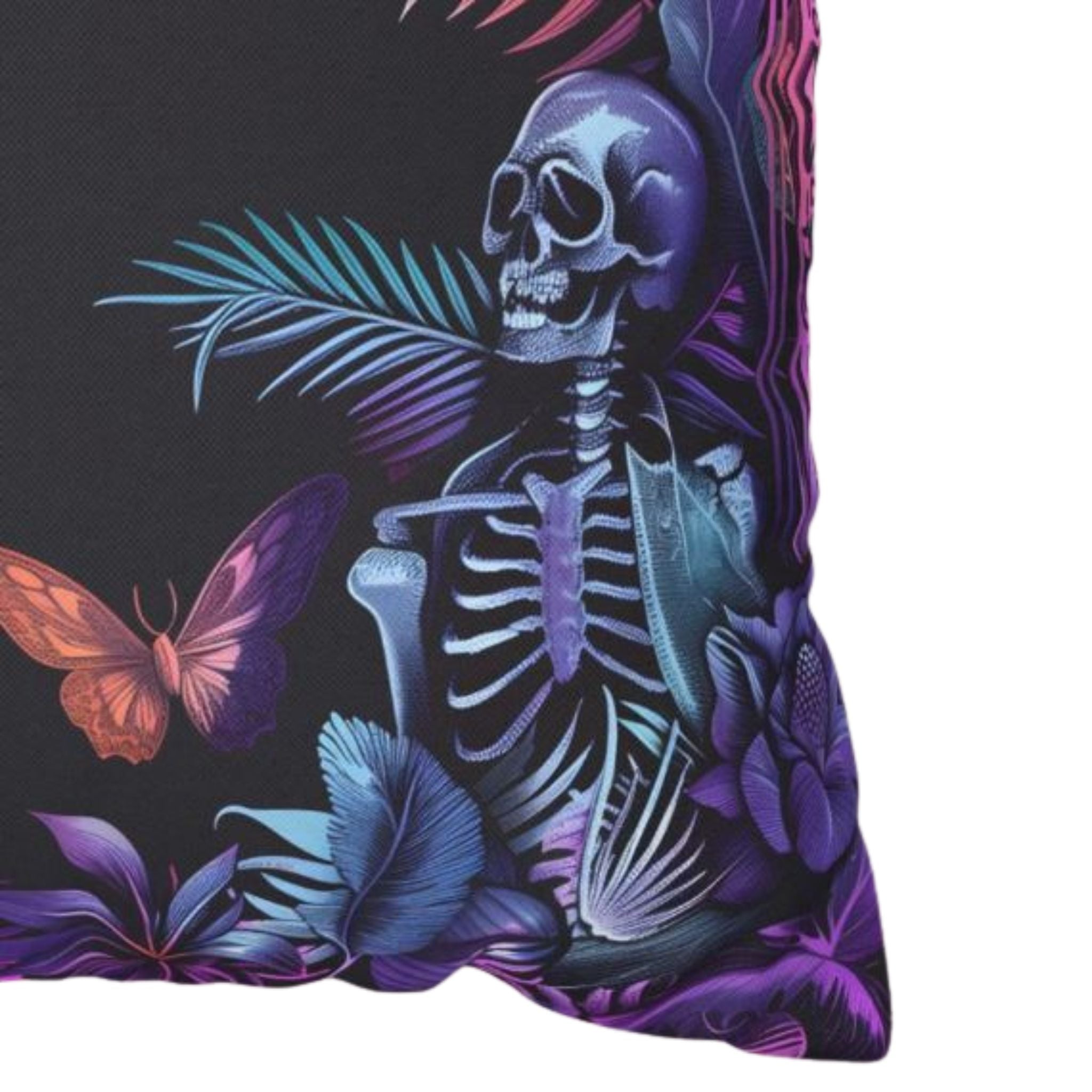 Gothic pillow cover closeup with a skeleton, butterfly, and floral design on a black background
