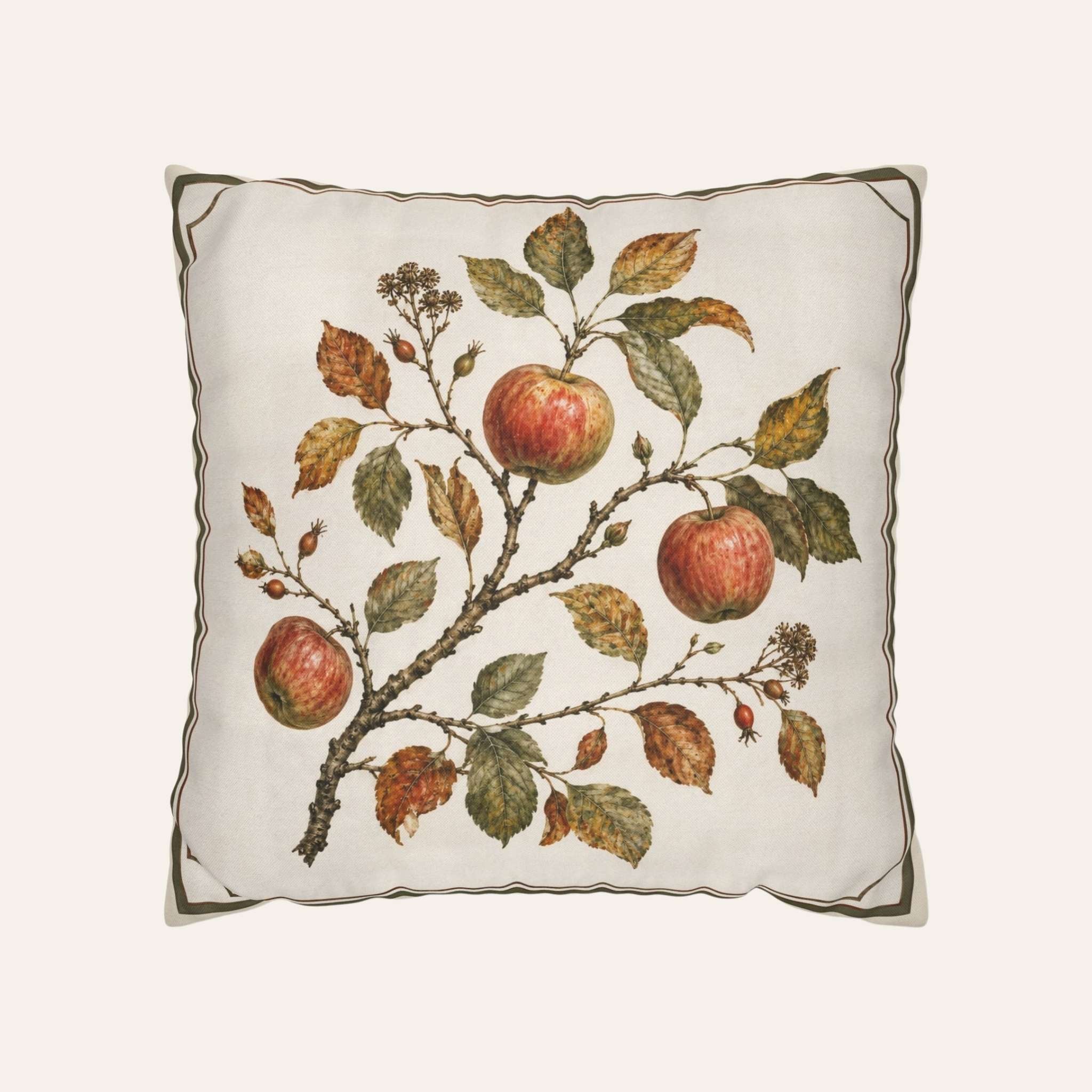 A square decorative throw pillow featuring a vintage print of red apples on a branch with green and brown leaves, set against a light cream background with a dark olive border.