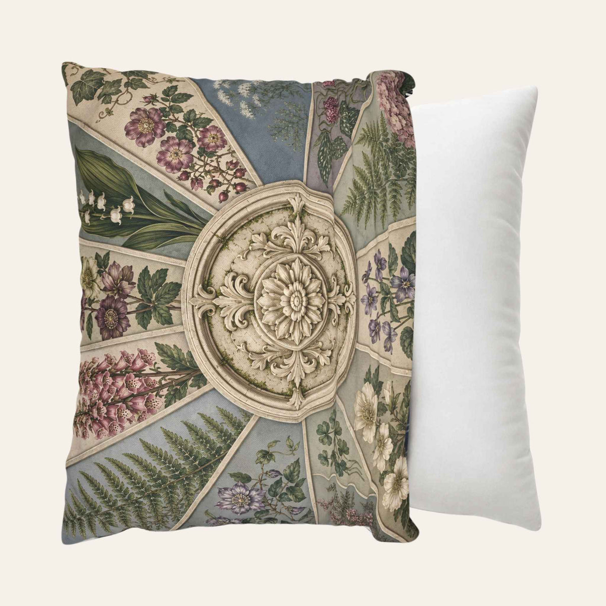 A square pillow cover featuring a vintage botanical and architectural medallion pattern, shown being placed onto a throw pillow.