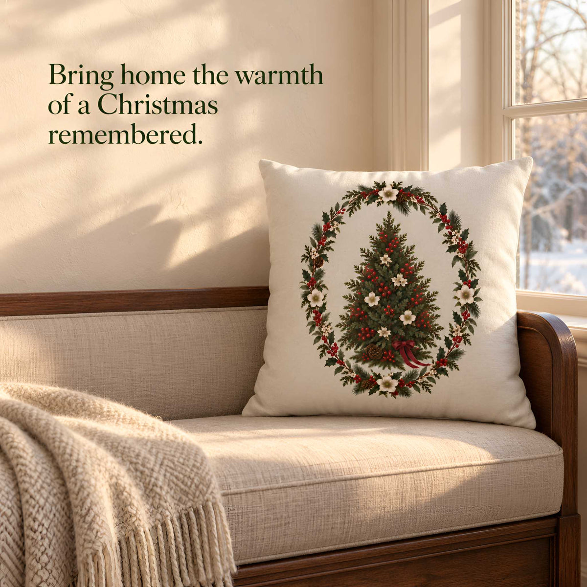 A cream throw pillow with a green Christmas tree wreath design, resting on a beige upholstered bench in a sunlit room with a window and a knitted blanket.