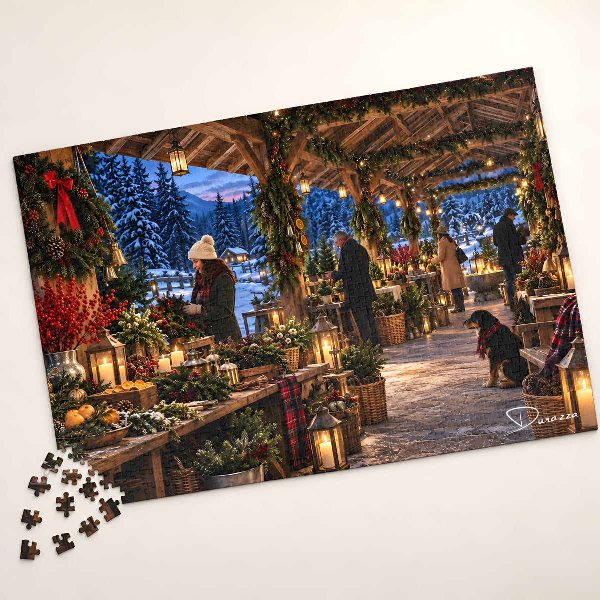 A completed jigsaw puzzle showing a festive winter market scene with people, lanterns, garlands, and snow-covered trees, photographed on a light neutral background with a few loose puzzle pieces in front.