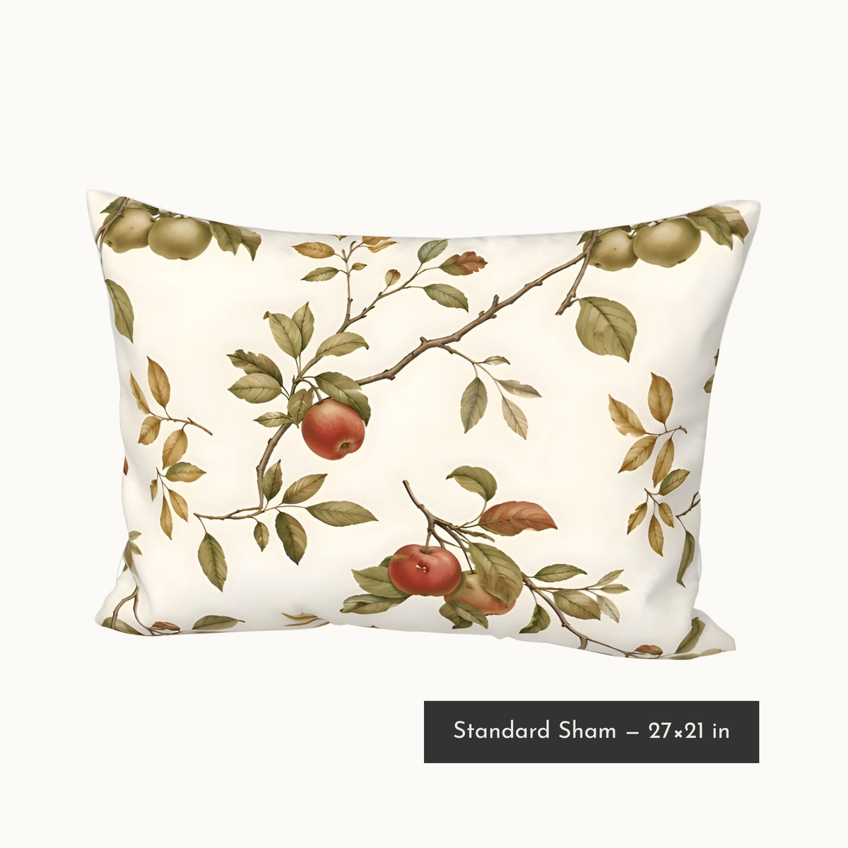 A standard pillow sham with an off-white background and a vintage-style botanical print of apple branches with green leaves and red apples. A black label at the bottom reads 'Standard Sham - 27x21 in'.