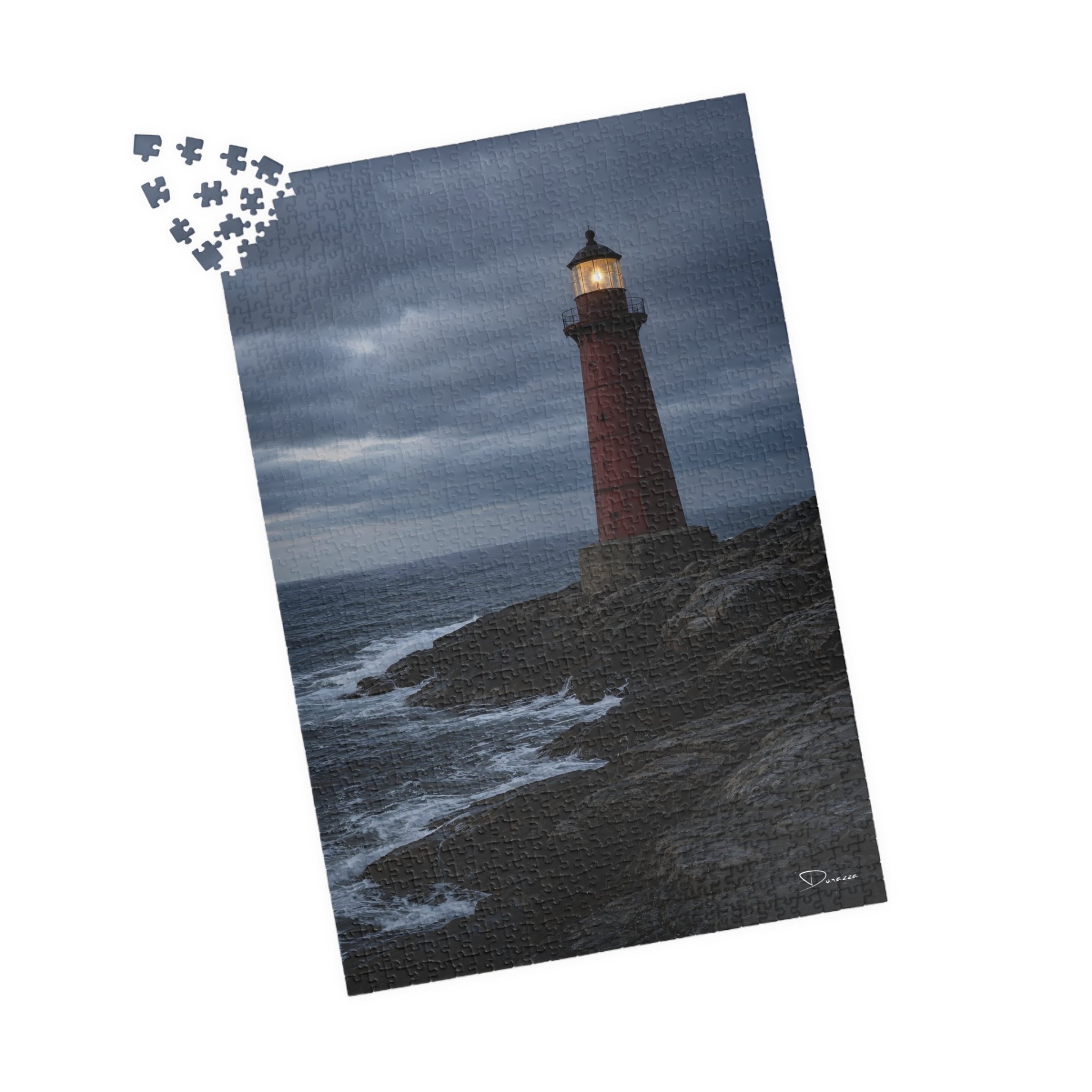 A 1000 piece Jigsaw puzzle with a lighthouse on a rocky island design