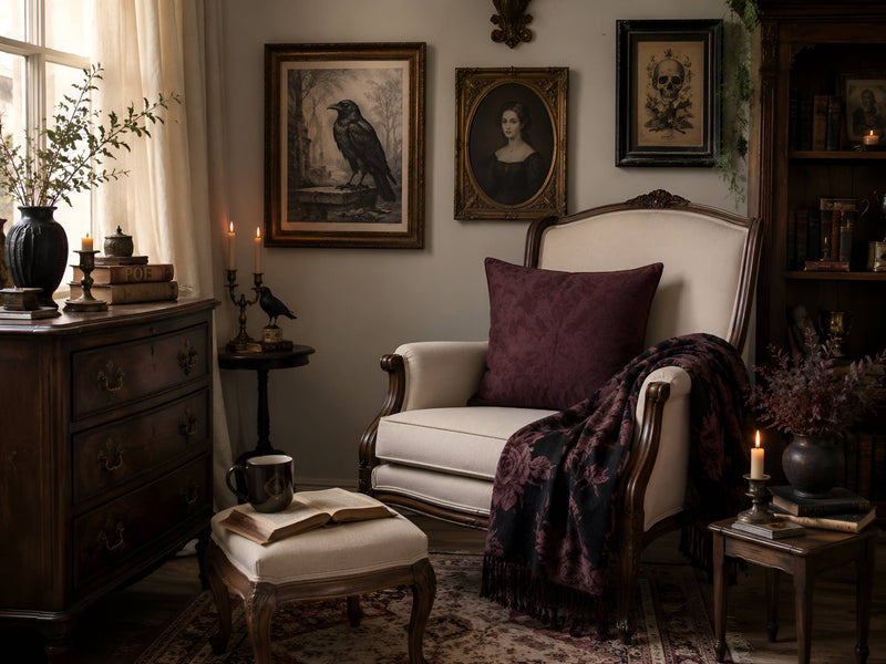 Victorian Gothic sitting room with raven wall art, antique portraits, plum pillow, dark floral throw, candles, and vintage furniture.