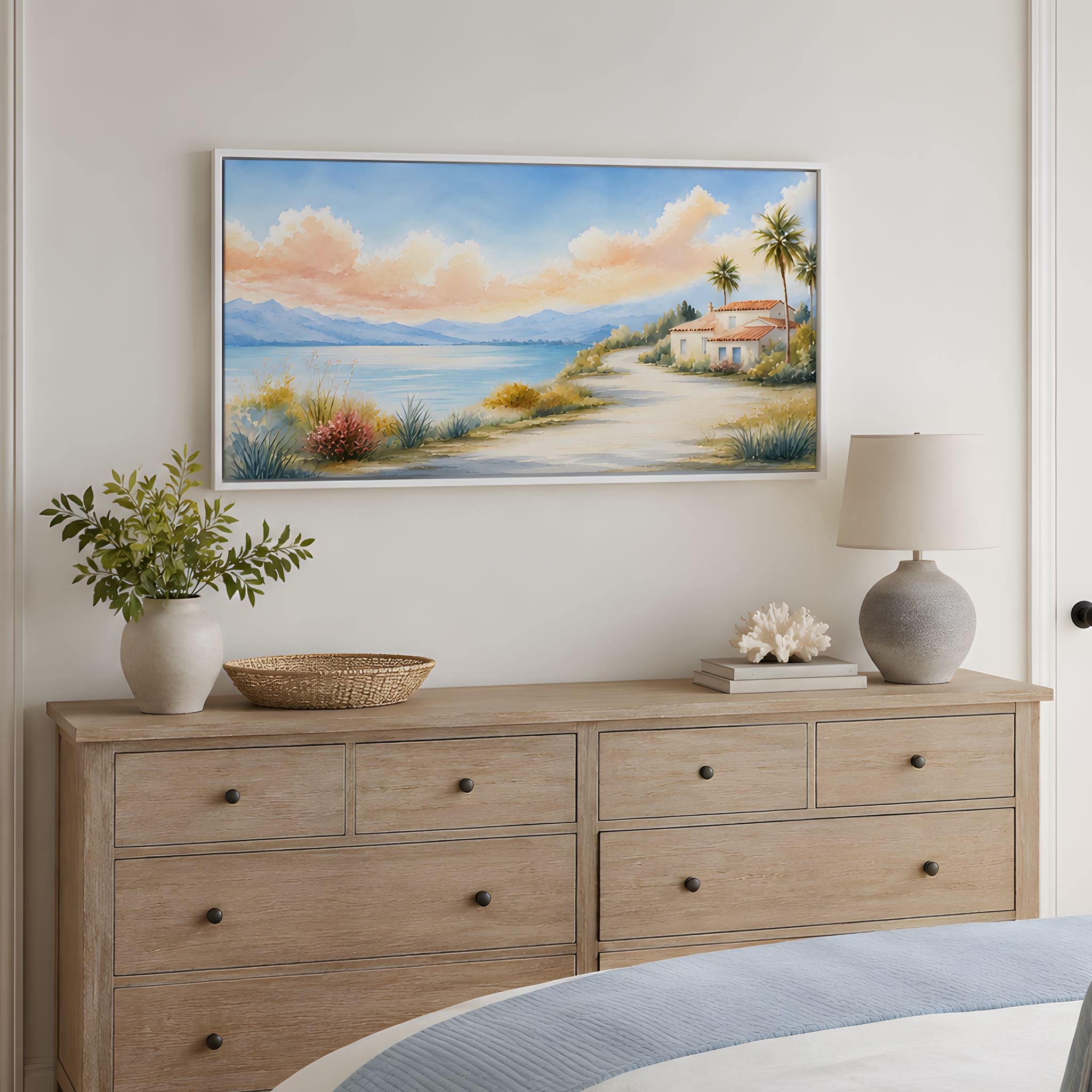 Wooden dresser with decorative items and a seaside home landscape scene for a Mediterranean home.