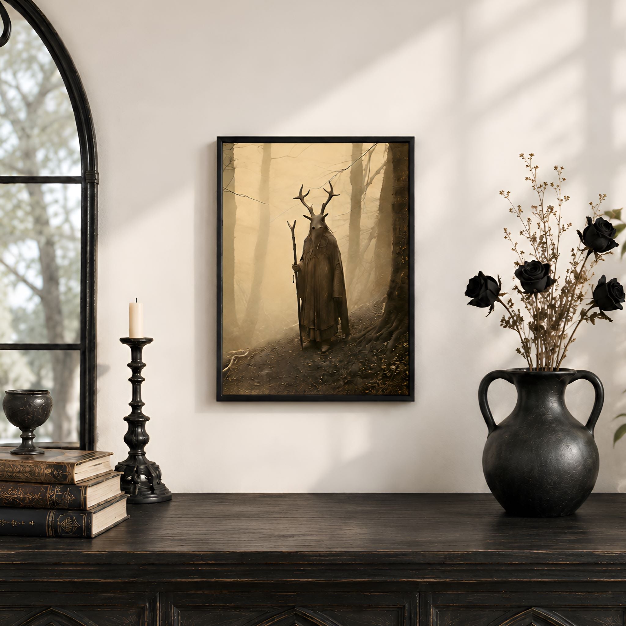 Framed artwork of a shaman with antlers on a wall above a wooden console table with decorative items.