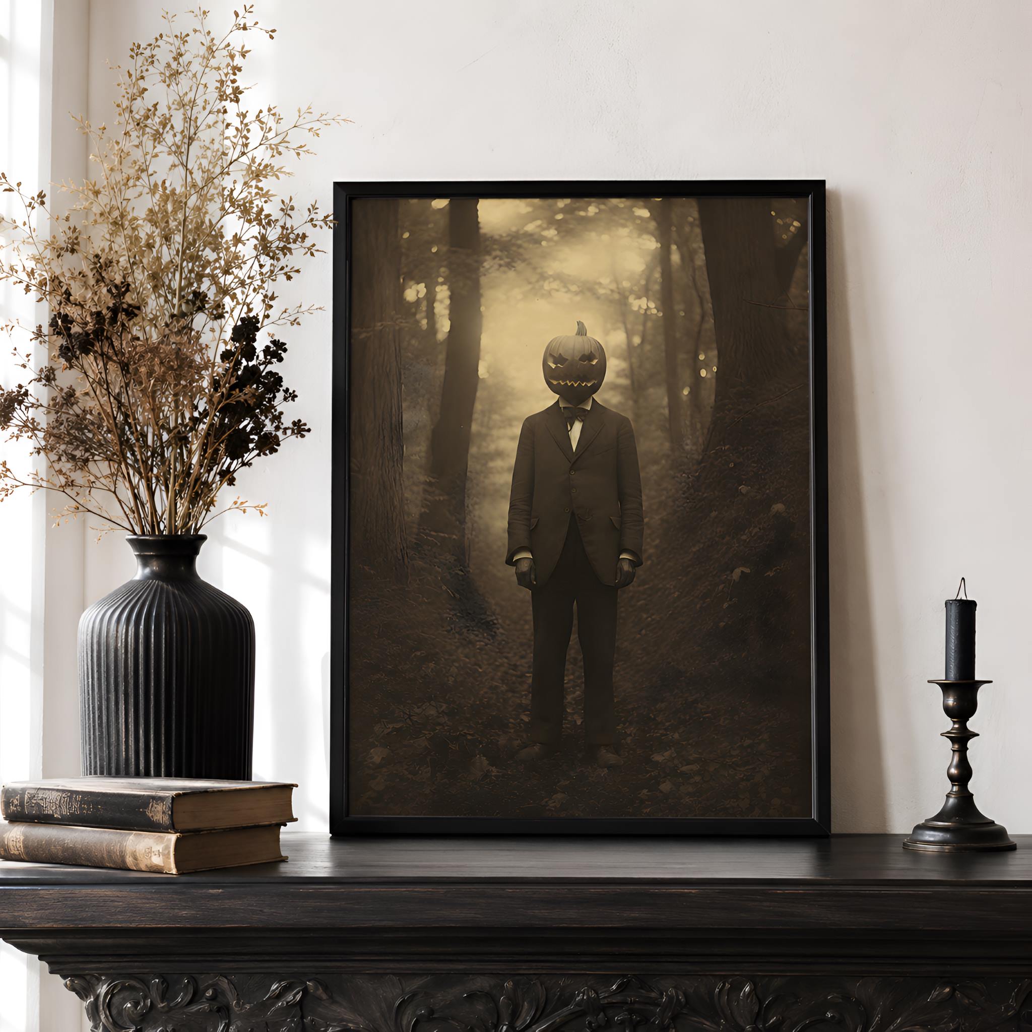 Framed gothic horror artwork of a person with a pumpkin head in a forest on a dark wooden surface.